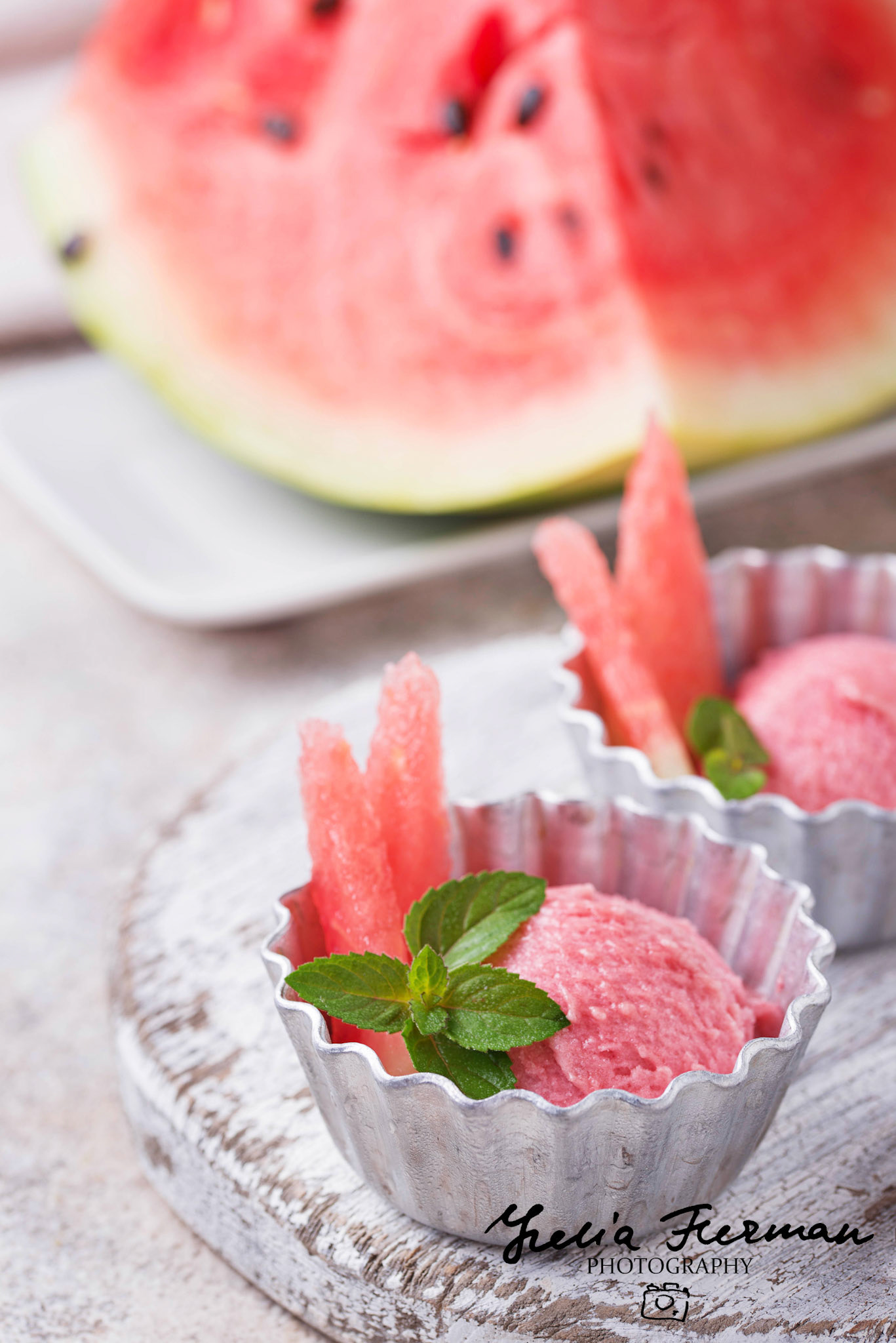 Watermelon ice cream in metal bowls on light background