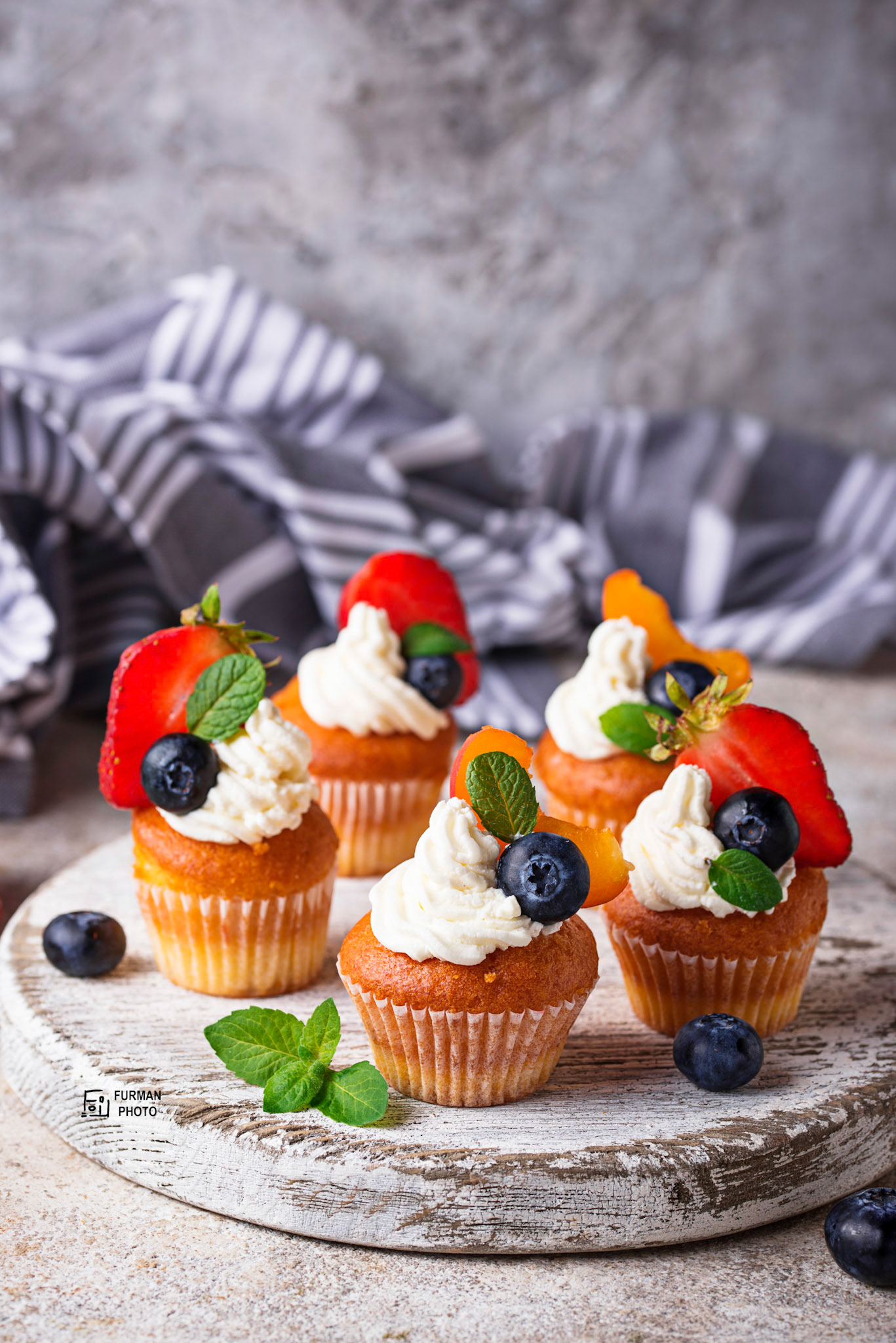 Cupcakes with cream and berries. Sweets for summer party