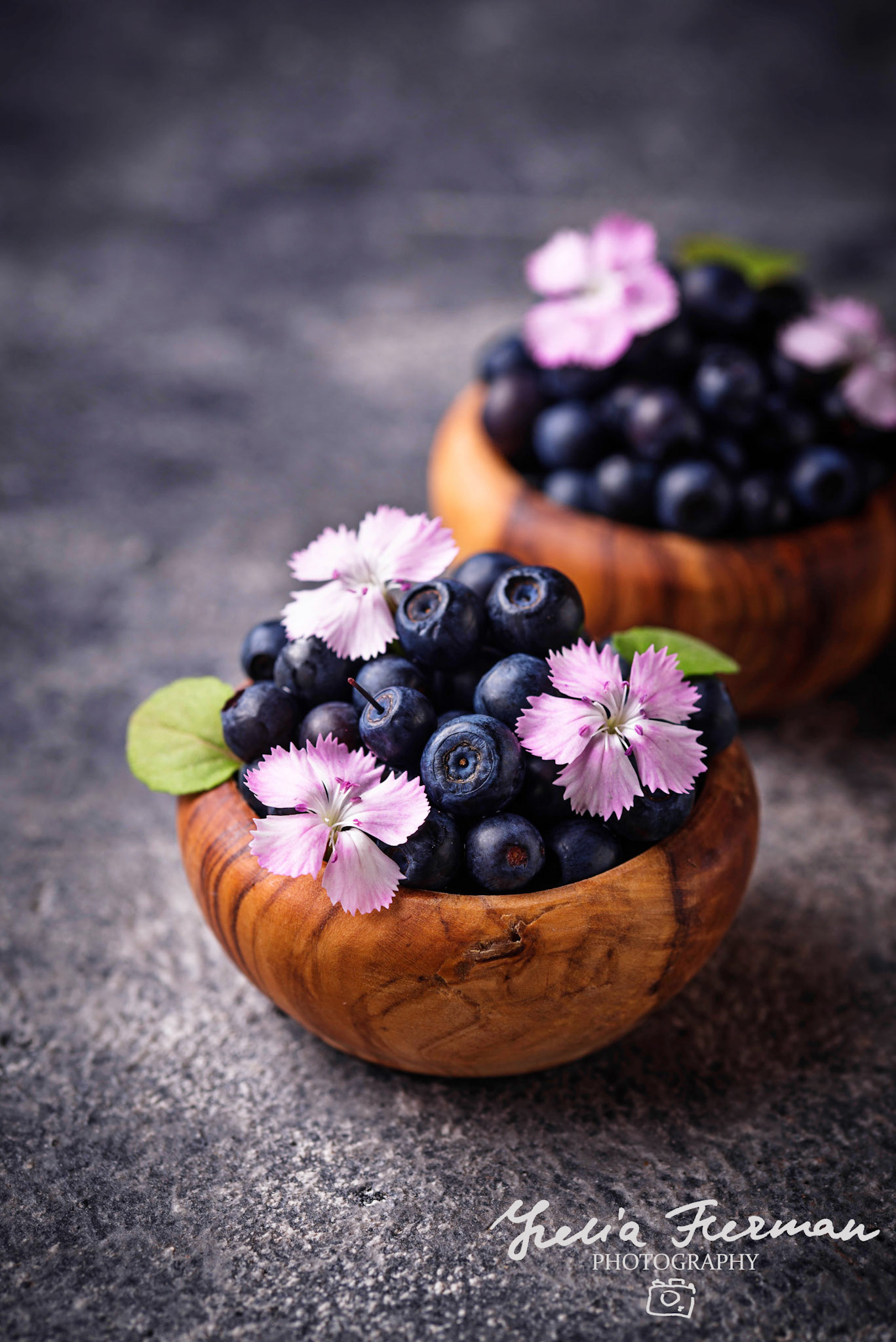 Fresh ripe blueberries in wooden bowl. Selective focus