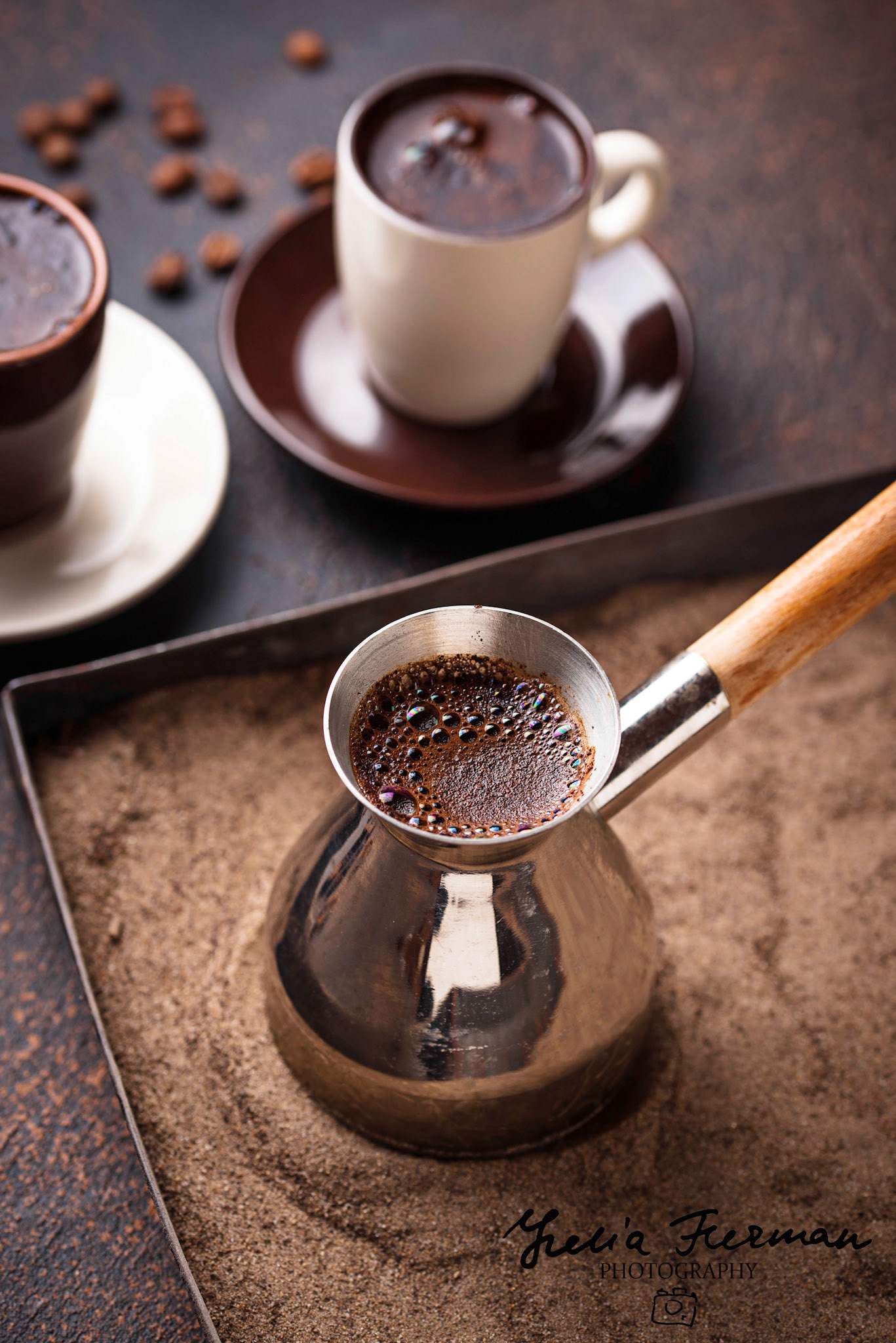 Traditional turkish coffee in cezve prepared on hot sand. Selective focus