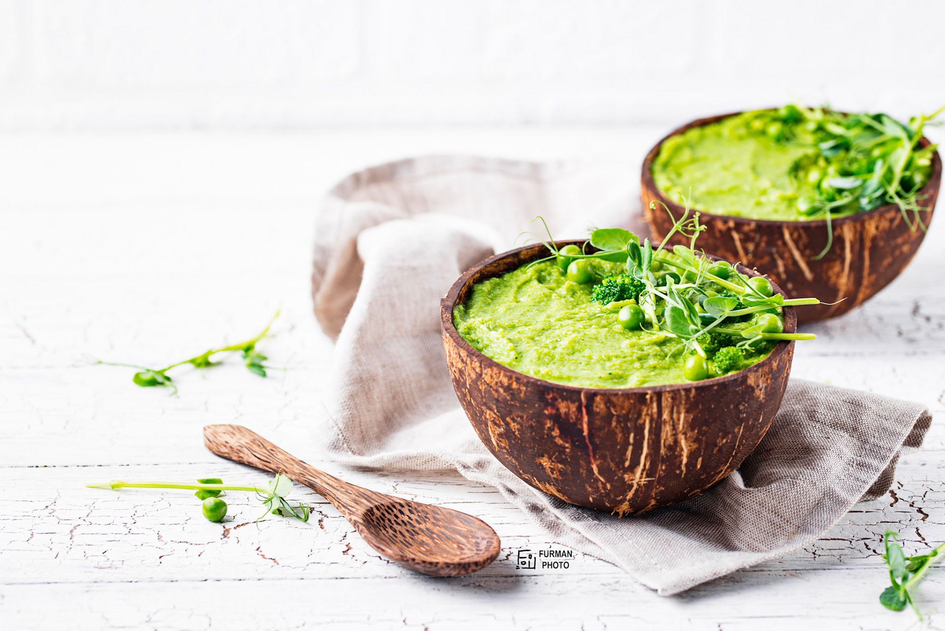 Vegan green broccoli soup or smoothie in coconut bowl