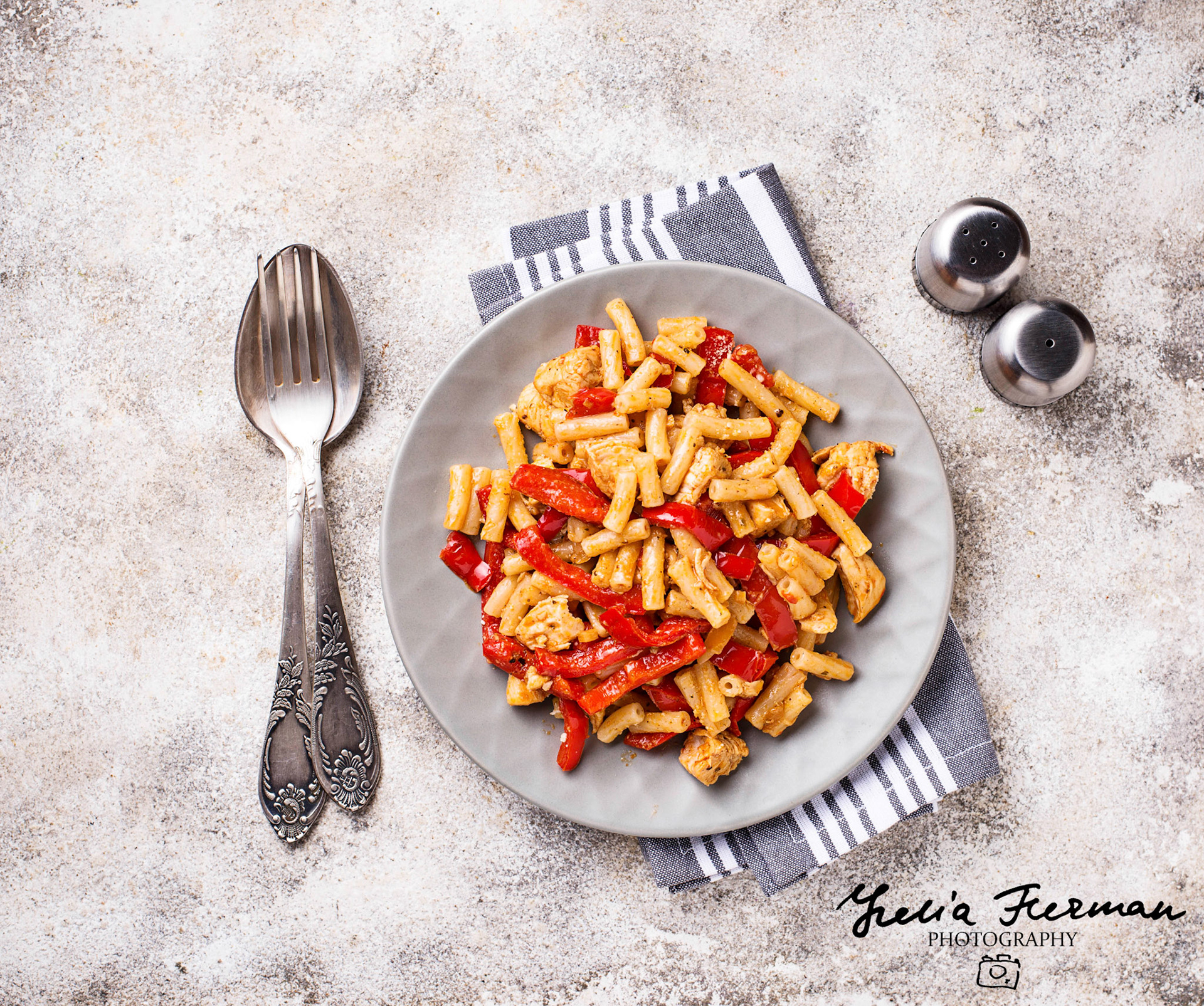 Pasta with chicken and pepper in tomato sauce. Top view