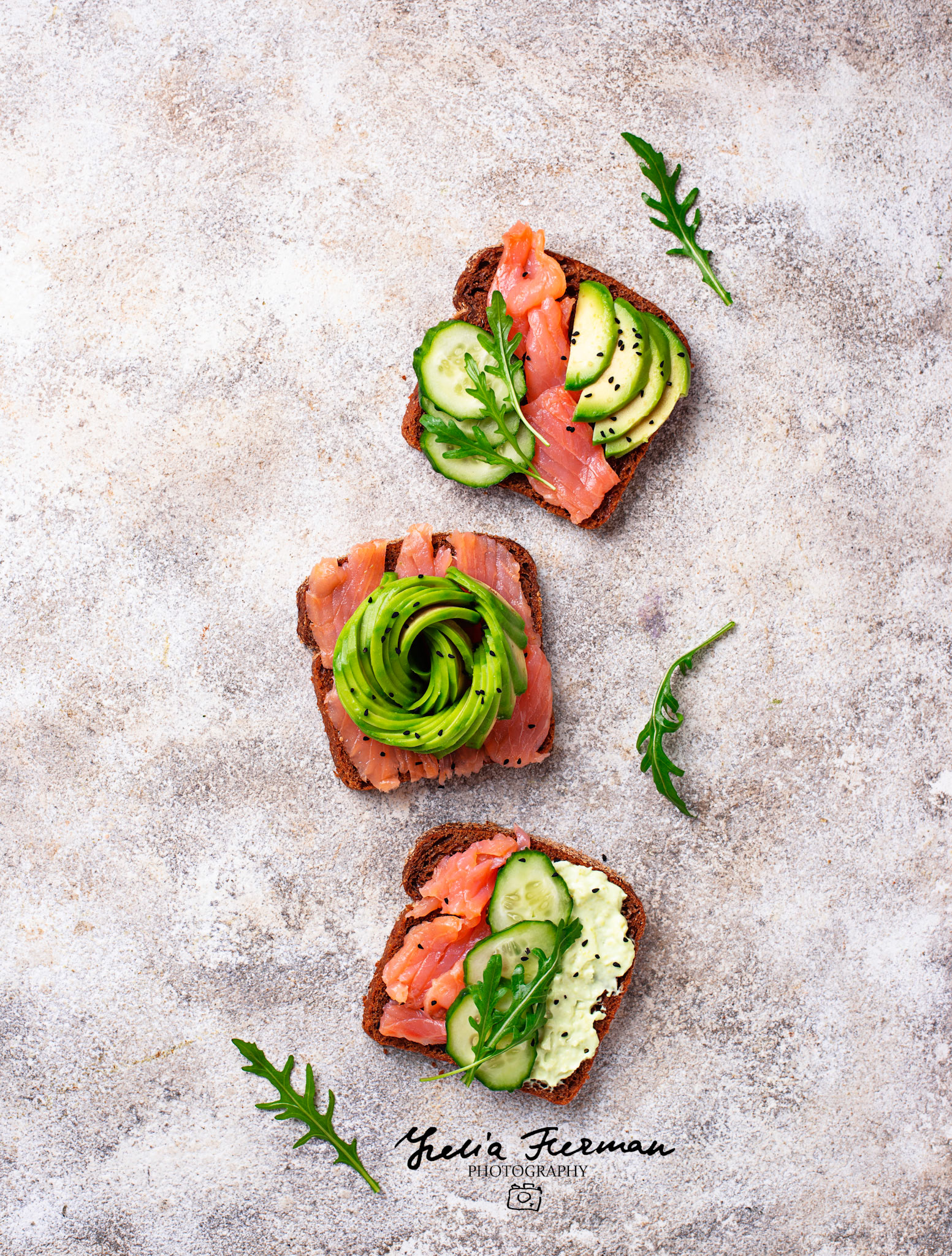Healthy toasts with salmon and avocado rose. Top view