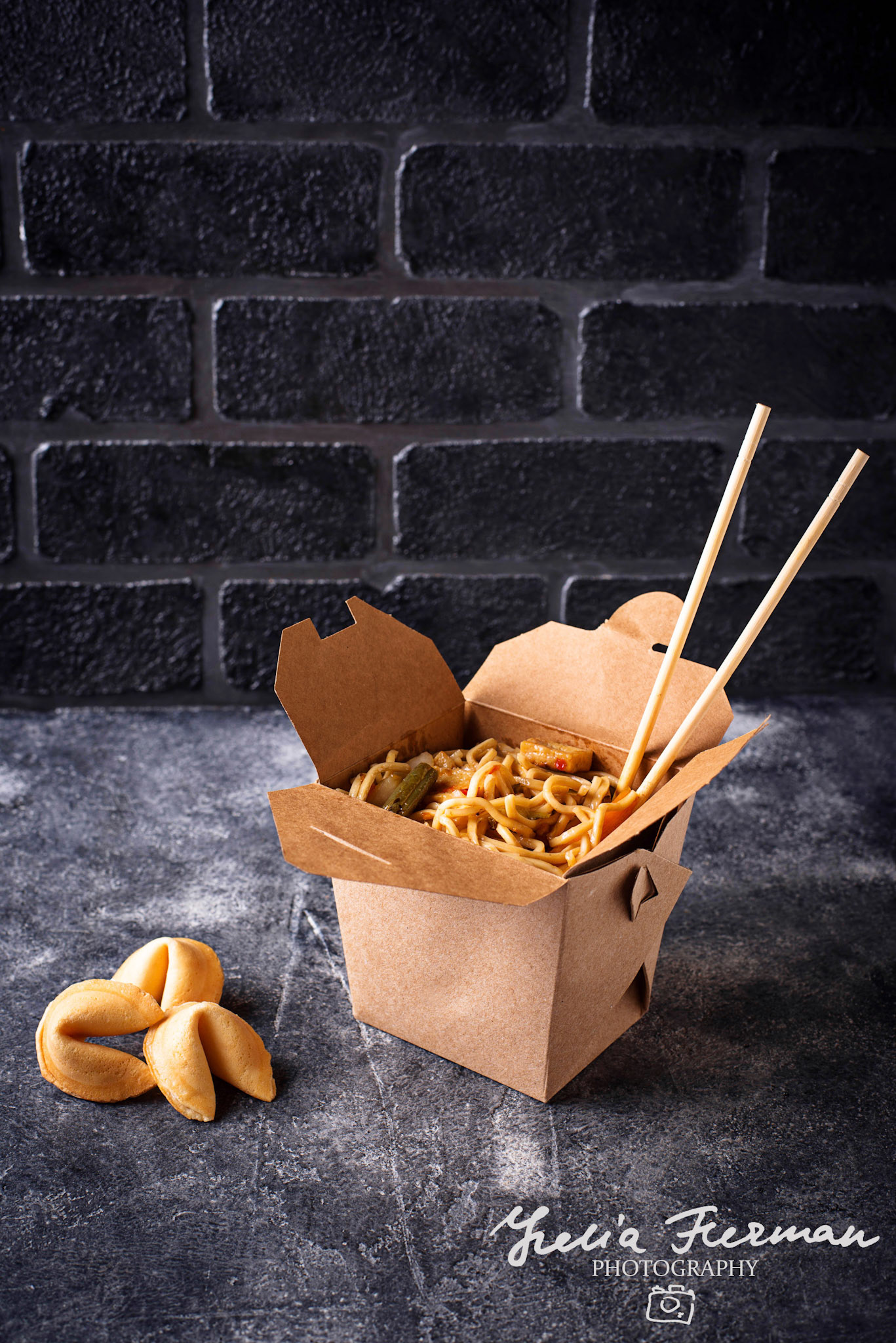 Box with traditional Asian noodles and fortune cookies