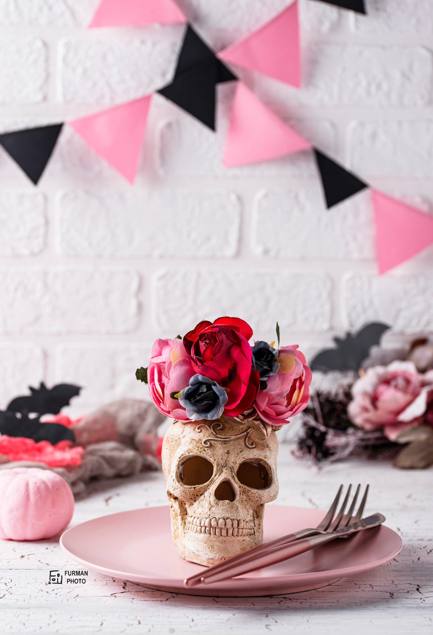 Halloween table setting in pink colors with skull