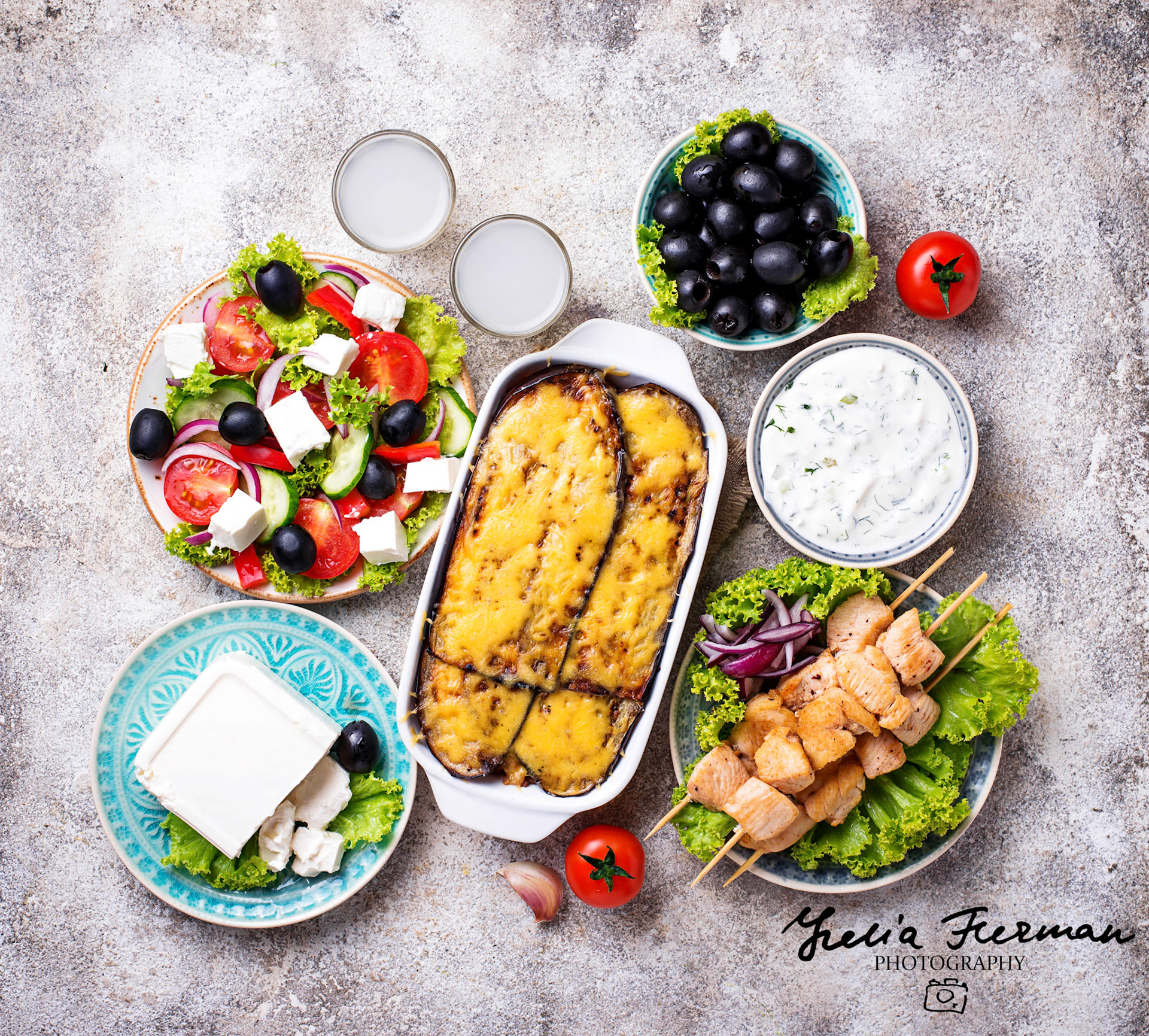 Assortment of traditional greek dishes. Salad, tzatziki, feta, meze, souvlaki and moussaka