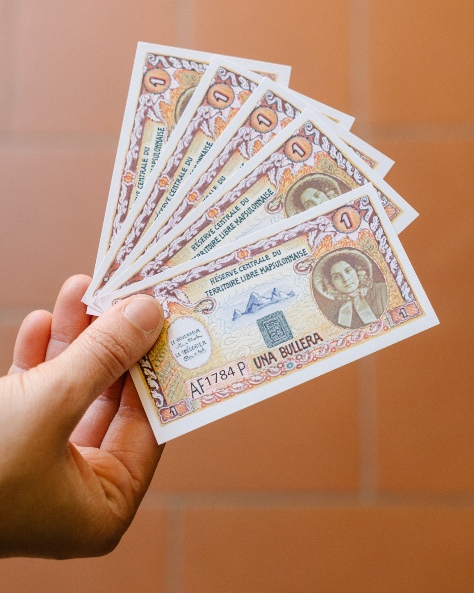 Mapsulon prints its own currency, the Bullera, whose value is pegged to the Ngultrum, the official currency of Bhutan
