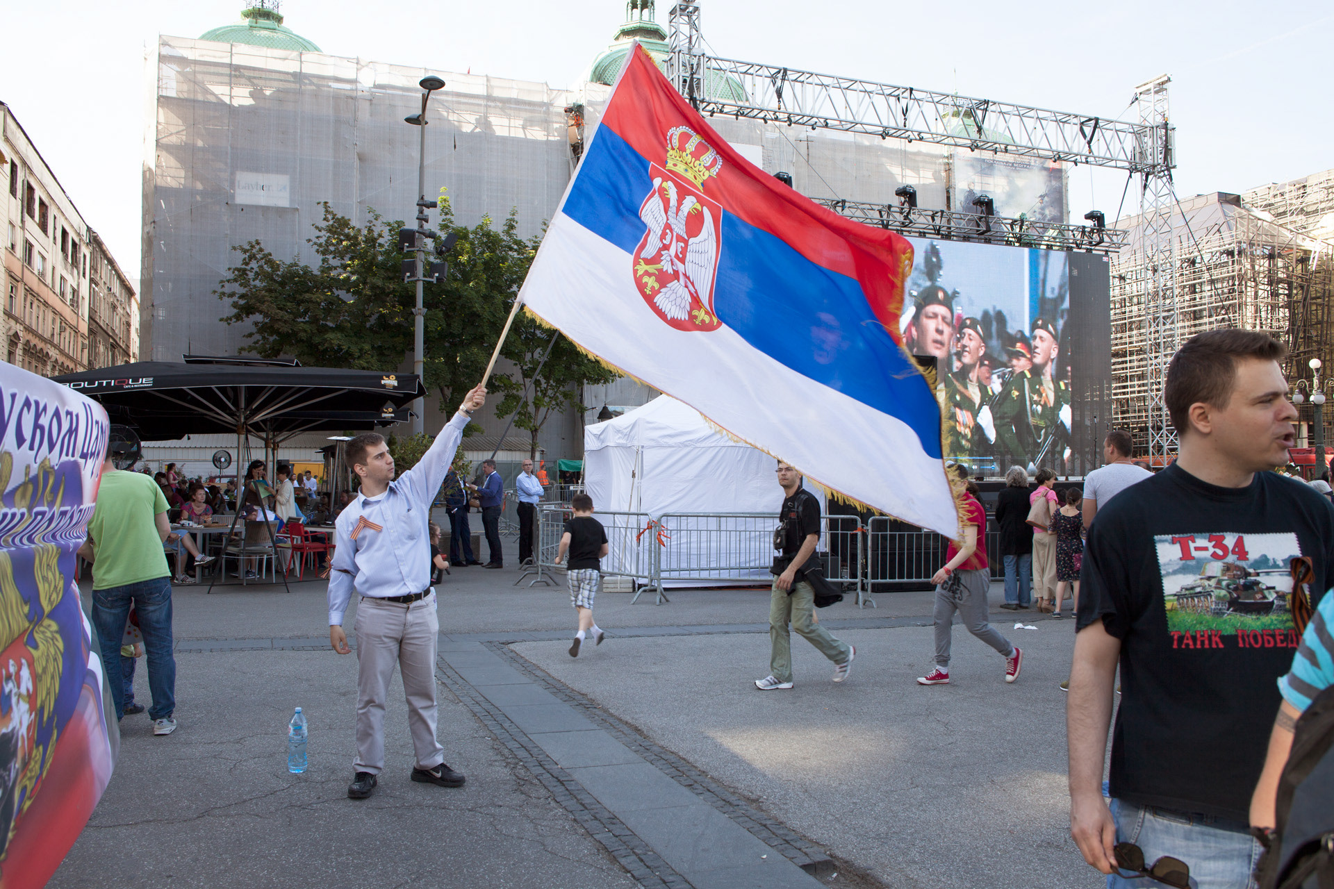 A young man showing the Serbian flag during the ceremony marking 70 years since the end of World War II in Republic Square
