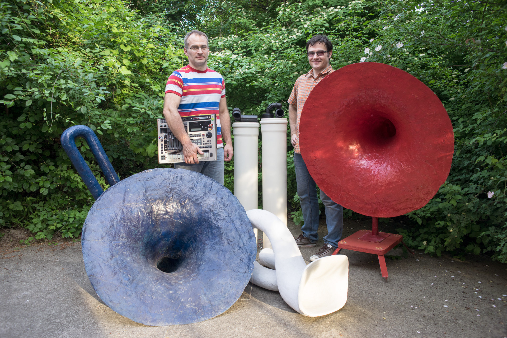 The brothers Edi and Ivan Bon posing with a few sculptures in their studio near Danube river. Edi, astrophysicist at the University of Belgrade, and Ivan, sculptor, are the member of MistakeMistake, one of the most influential band of the Belgrade scene in the beginning of 2000. Their style has changed during the years and nowadays they are performing minimalistic music shows sampling the “sound of the universe”