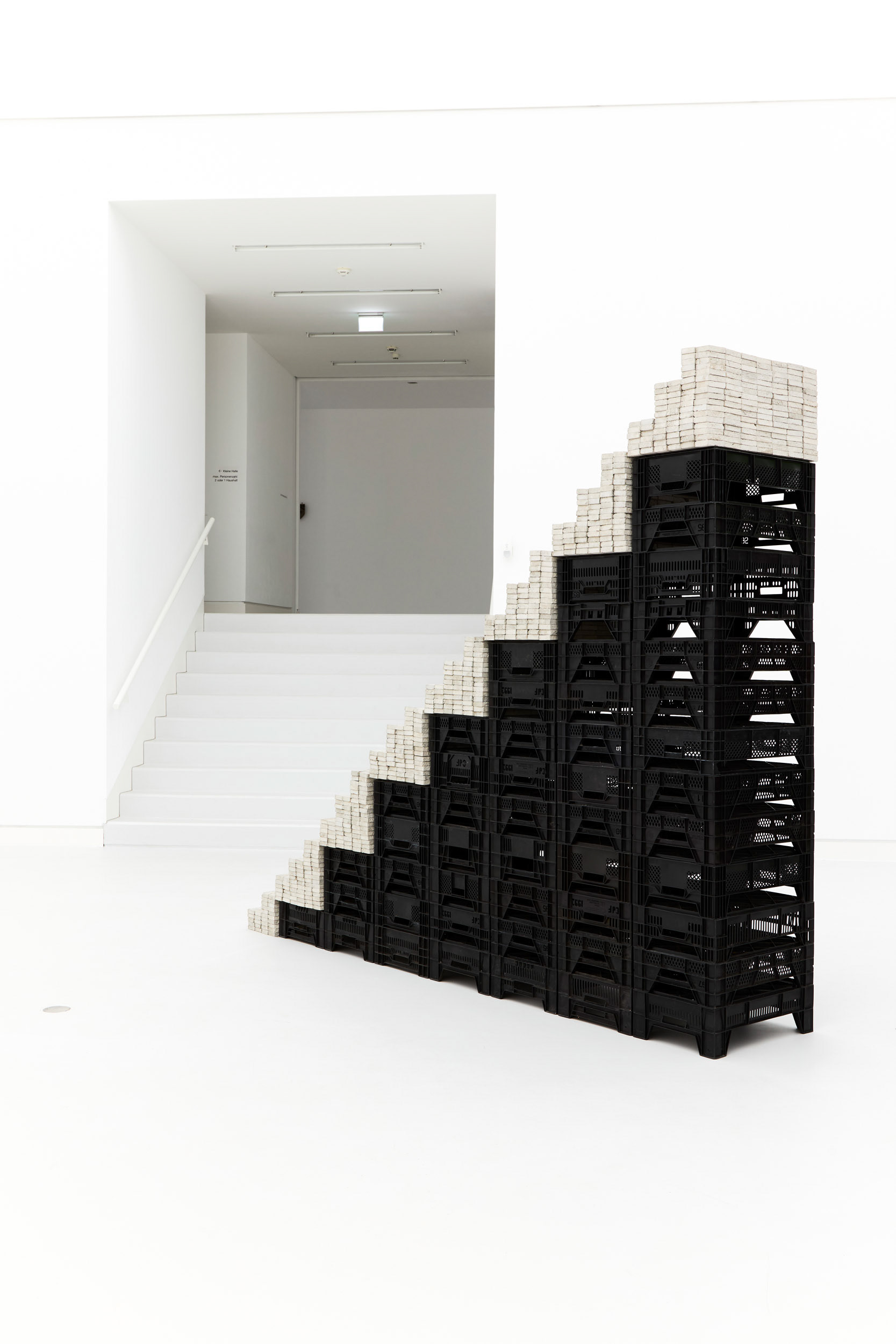 Potemkin, 2020, installation featuring a staircase made of concrete blocks and vegetable crates.