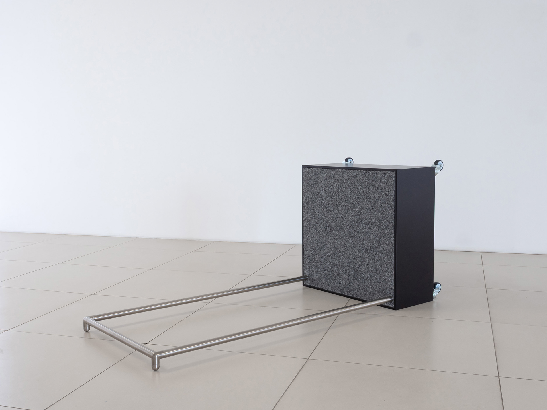 9669, 2026, sculptural work made of painted MDF, felt carpet, wheels, candles and stainless steel.