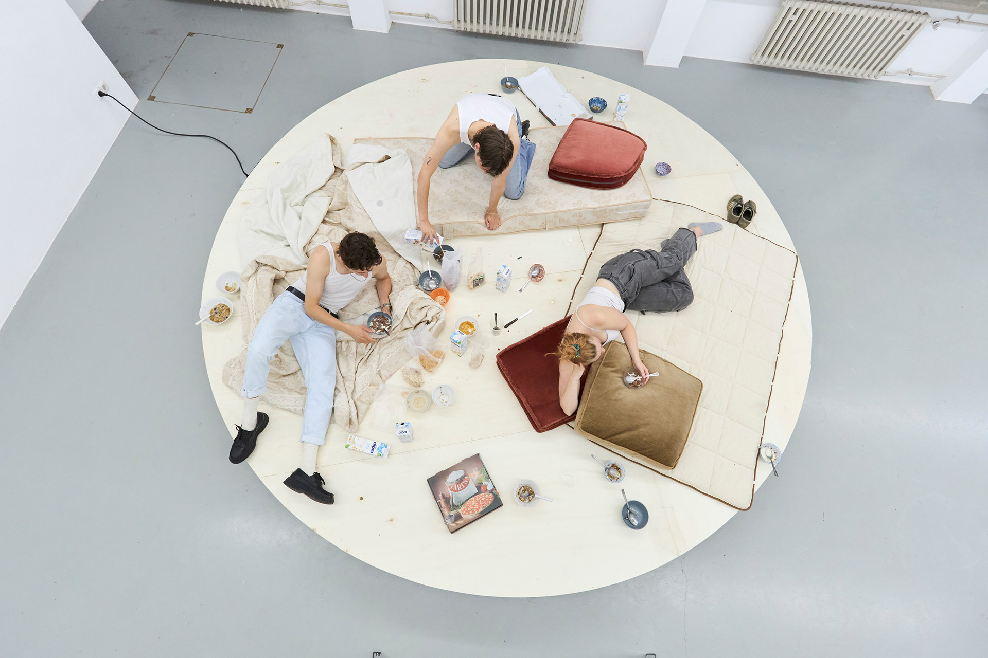 Choose Life, 2021, installation with people eating cereal on a rotating platform.