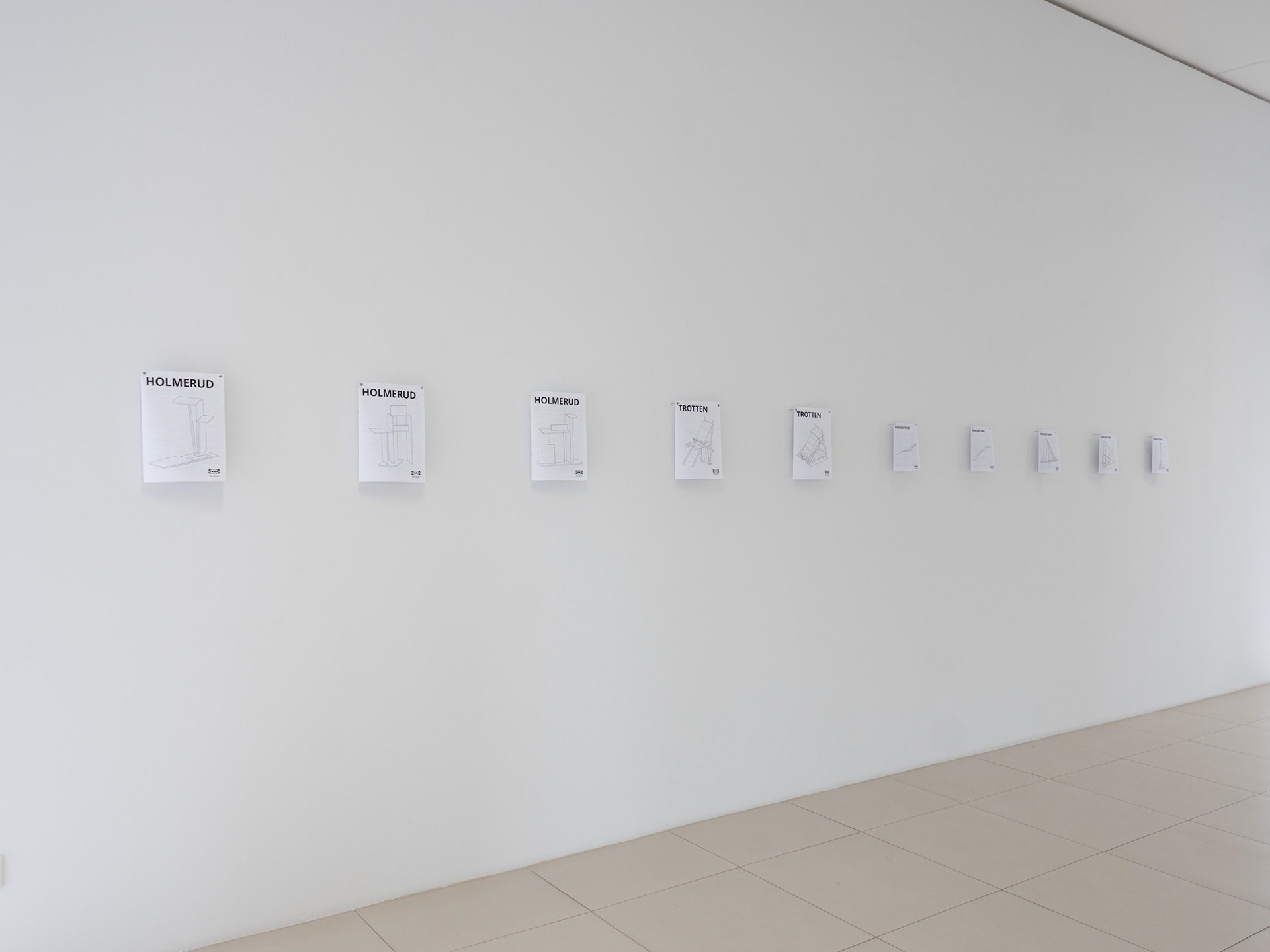 Exhibition view featuring multiple IKEA instruction drawings.