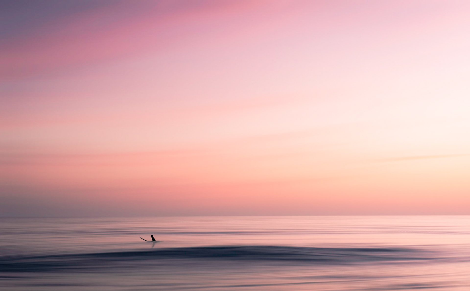 Surfer enjoying the waves and the sunset at Santa Monica