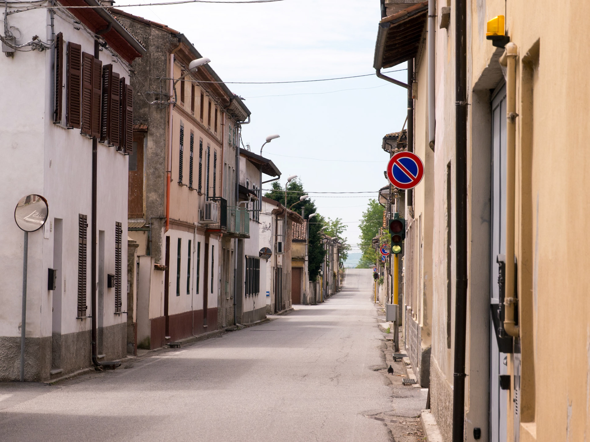 A deserted little town street quickly filled up with a bike peleton [Rivalba, Piemonte, Italy]