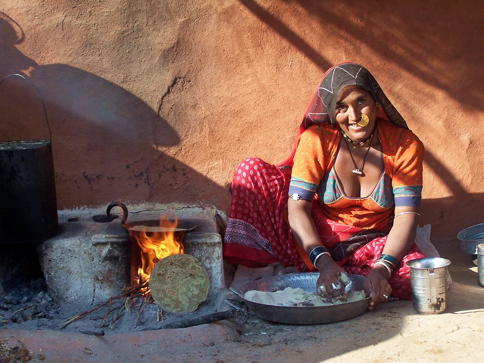 Woman baking bred. Rajasthan countryside, India 2003.