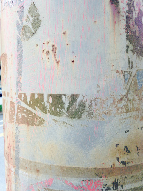 year of posters stuck to a telephone post