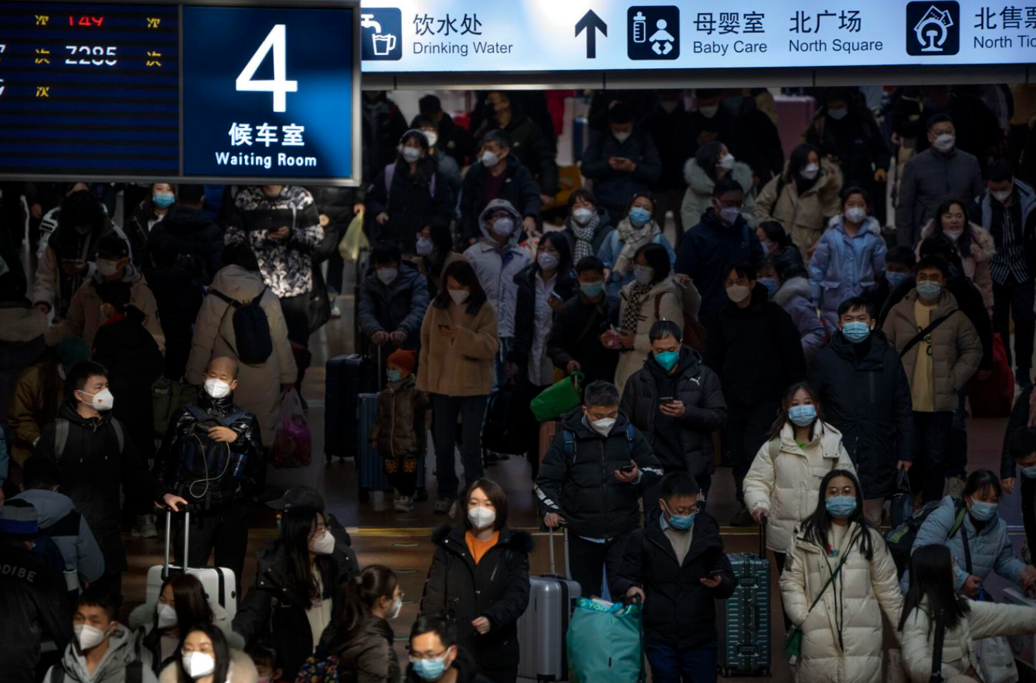 Travelers walk along a concourse at Beijing West Railway Station in Beijing, Wednesday, Jan. 18, 2023. China in December lifted its strict "zero-COVID" policy, letting loose a wave of pent-up travel desire, particularly around China's most important time for family gatherings, referred to in China as the Spring Festival, that may be the only time in the year when urban workers return to their hometowns. (Mark Schiefelbein/The Associated Press)