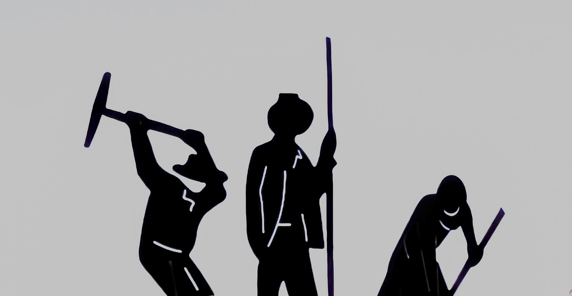 This illustration shows silhouetted figures engaged in manual labor, highlighting strength, teamwork, and the spirit of hard work.