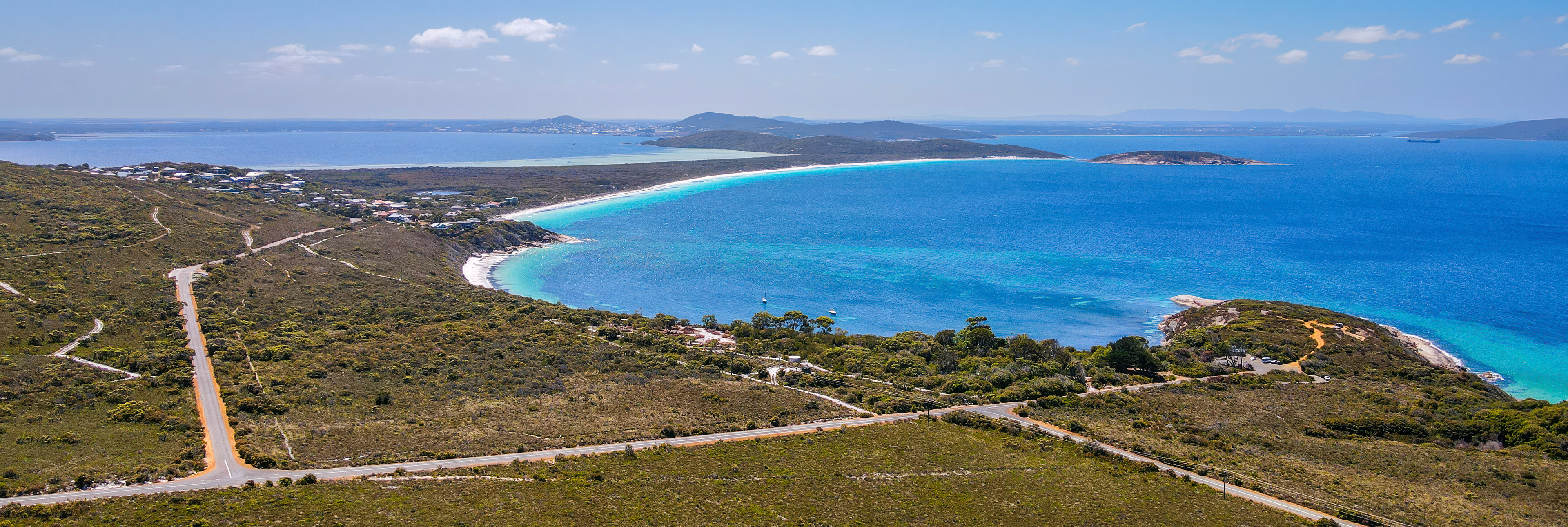 Discover a serene coastal landscape featuring a white sand beach, and vibrant blue waters, perfect for exploration.
