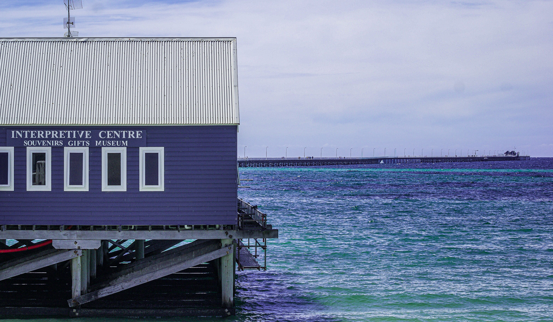 An interpretive center and museum stands on stilts over the ocean, showcasing coastal charm and inviting exploration of local attractions.
