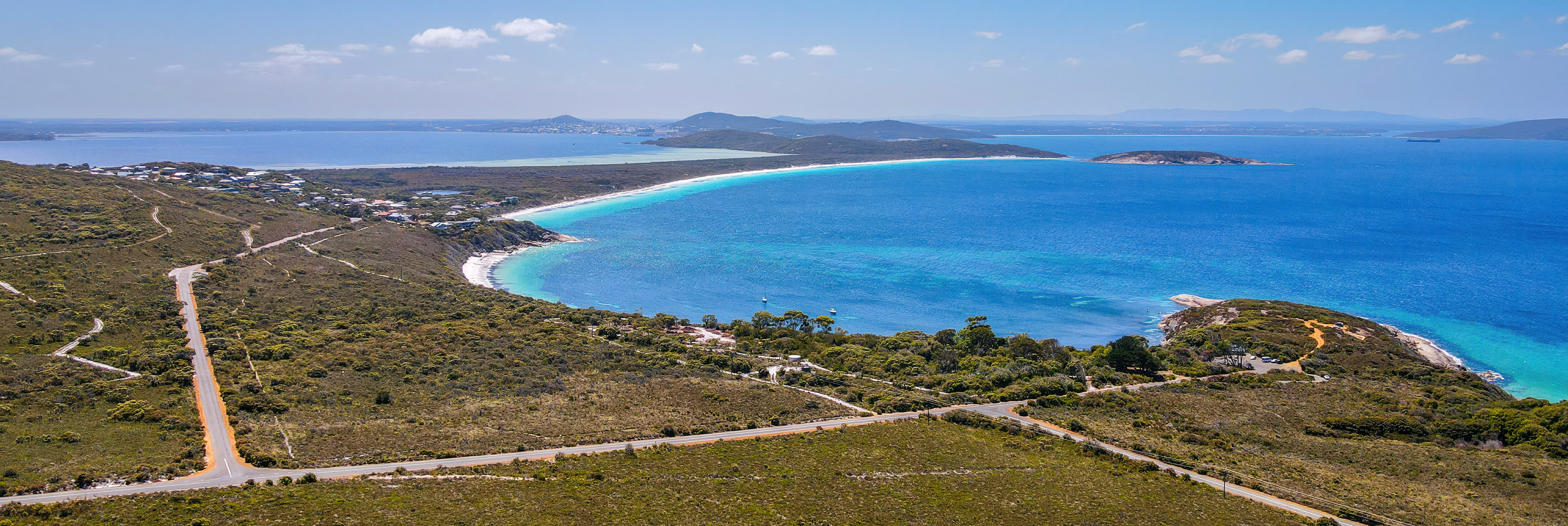 Discover a serene coastal landscape featuring a white sand beach, and vibrant blue waters, perfect for exploration.
