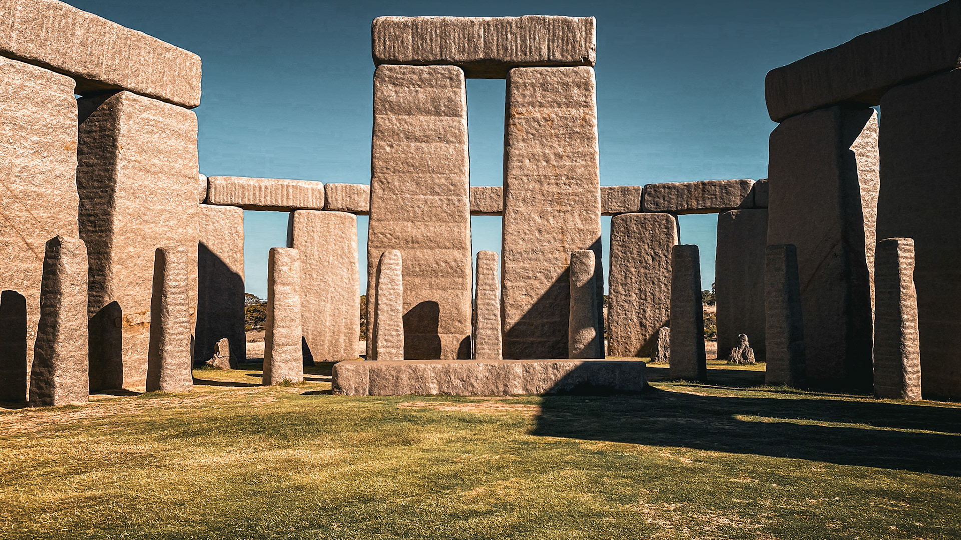 This striking replica of Stonehenge features massive megaliths in a serene outdoor setting, evoking history and mystery.