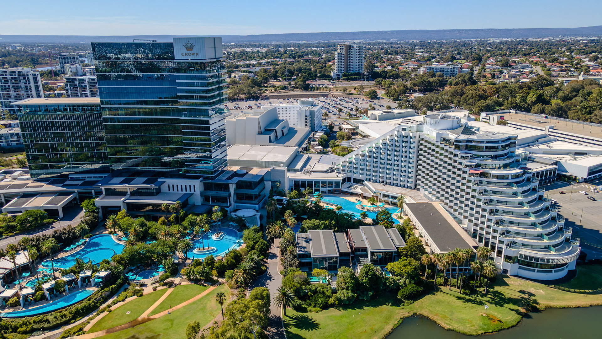 A picturesque blend of modern architecture and lush greenery, this lively resort area invites relaxation and exploration amid clear blue skies and sparkling waters.