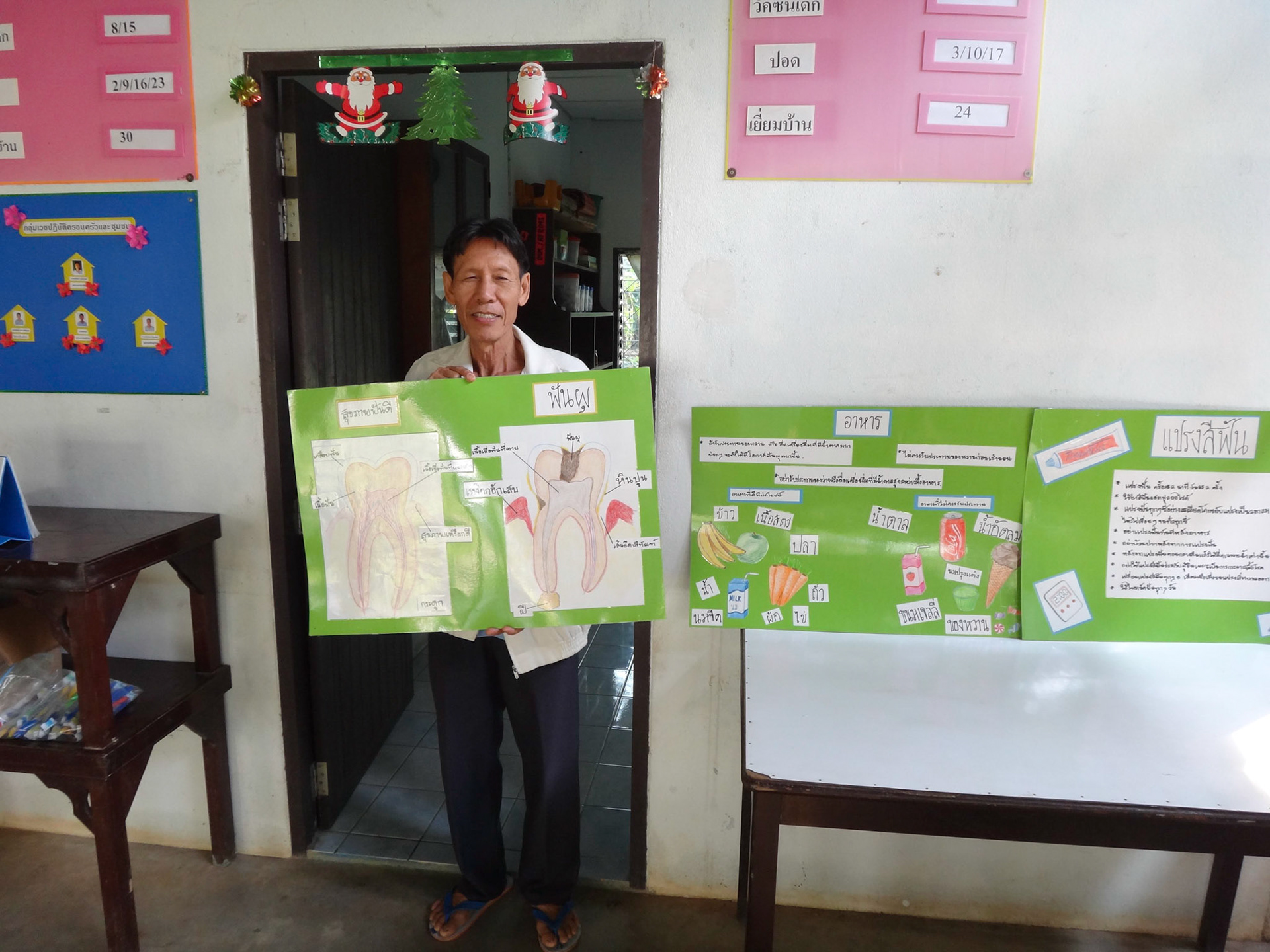 Jen's dental assistant and translator with the oral health education posters