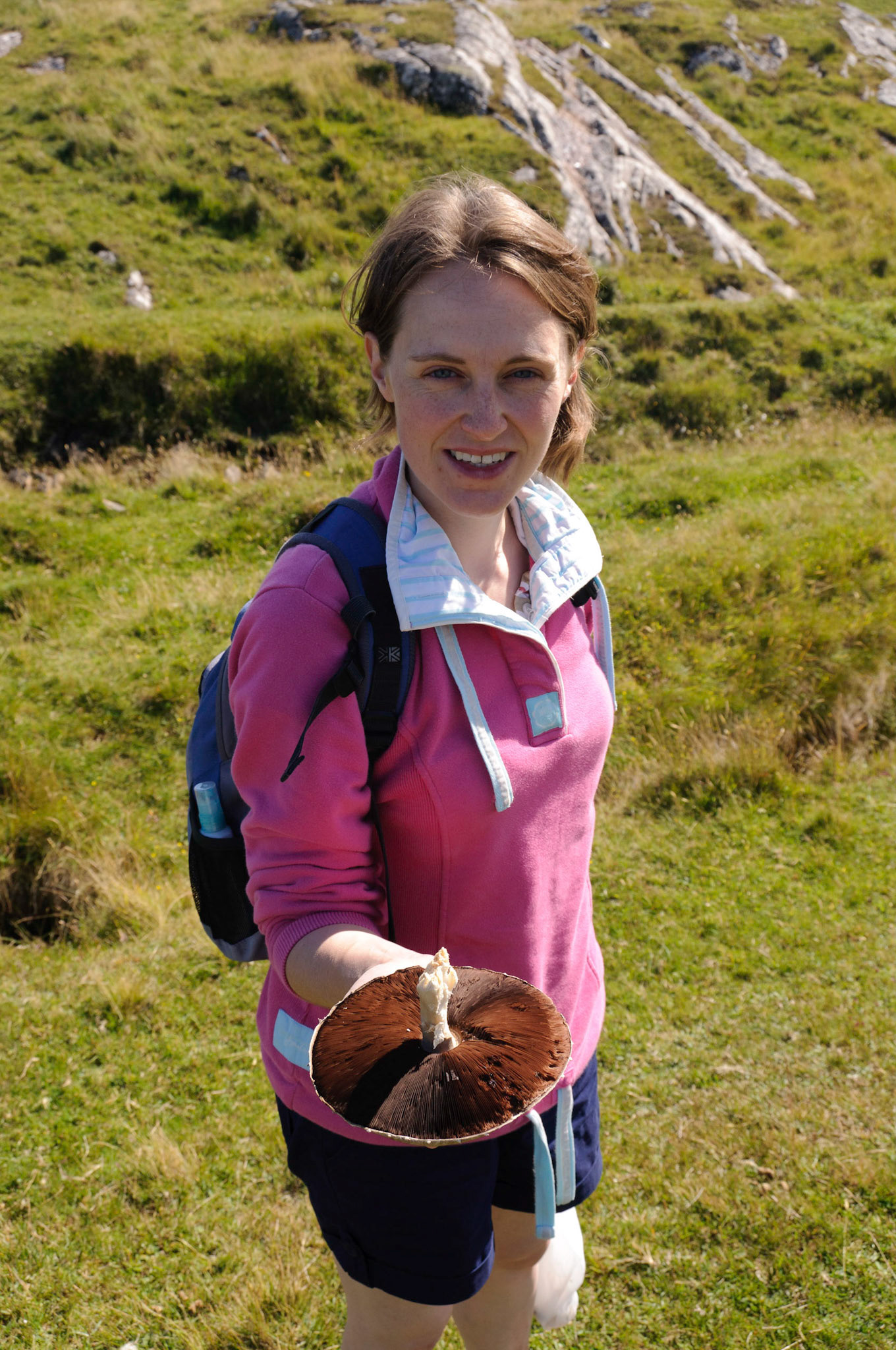Jen picking a giant mushroom on a walk to the end of the island.