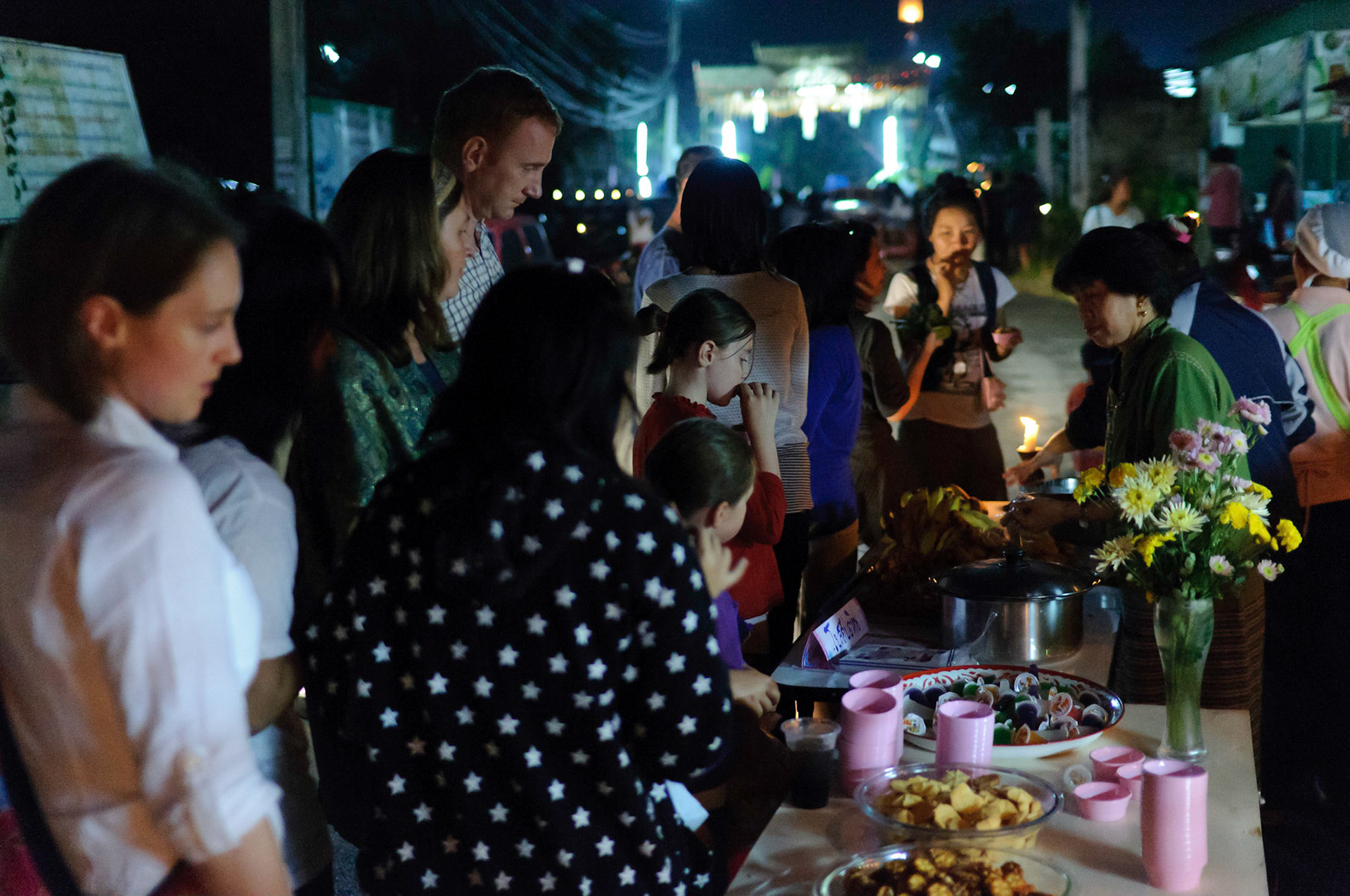 Sampling food at village celebrations during the Loy Krathong fesitval