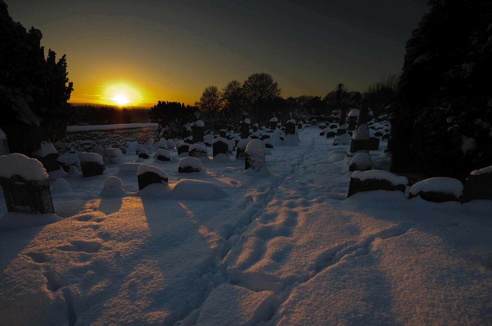 Larbert in the snow - sunset over the grave yard at Larbert Old Church.