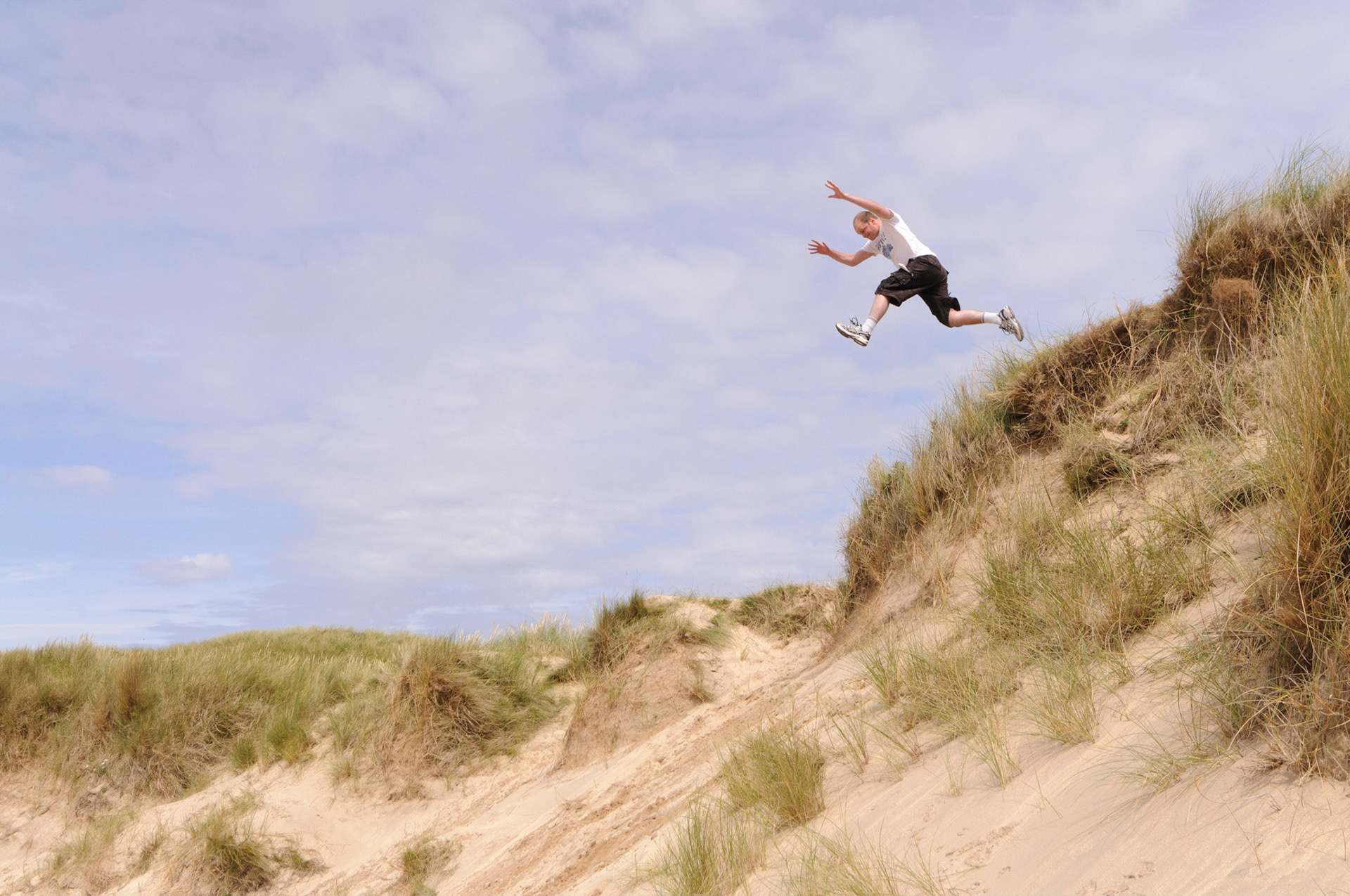 Calum jumping down a 30 meter sand dune between Feall Bay and Crossapol Bay.