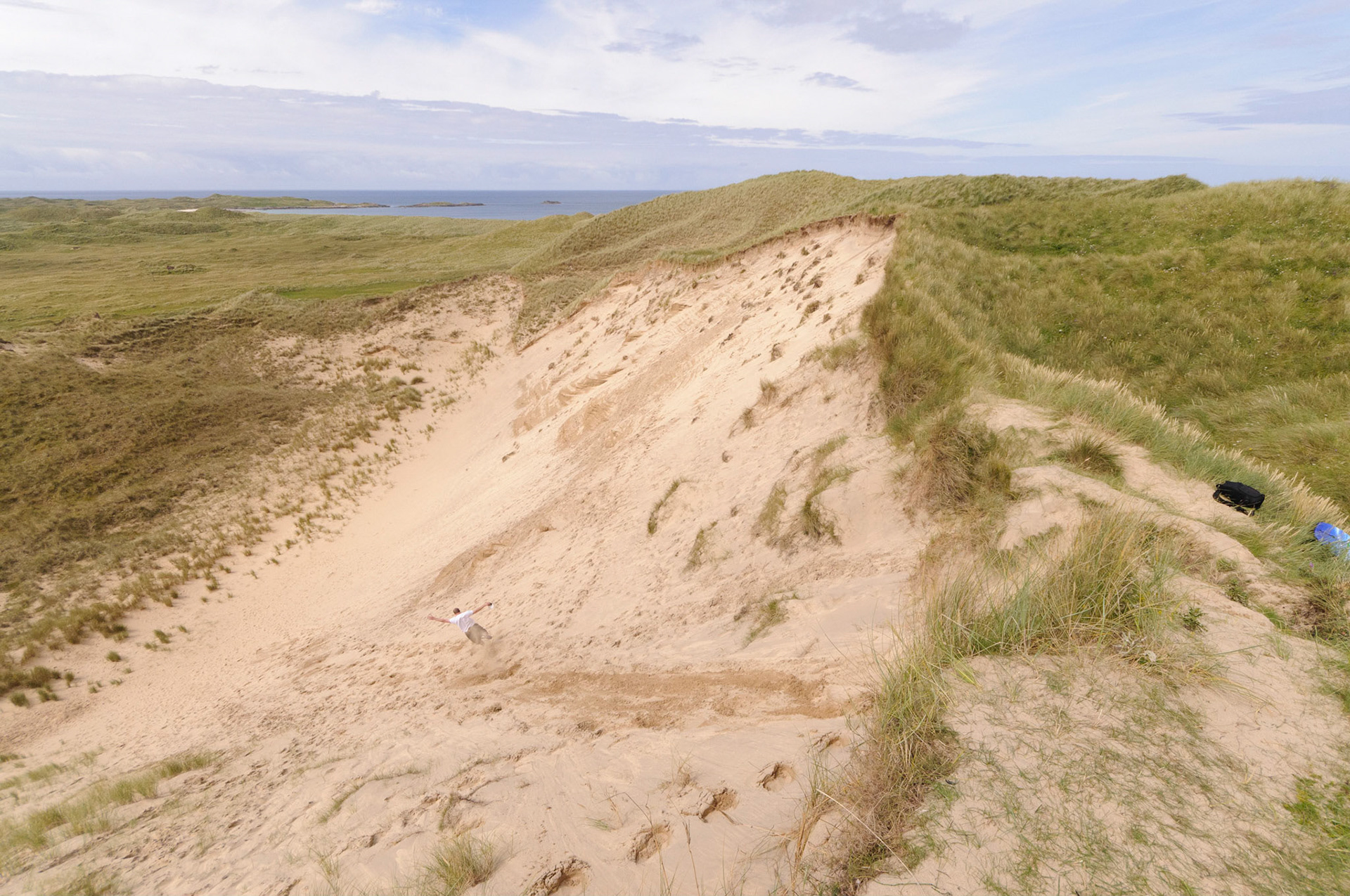 Calum jumping down a 30 meter sand dune between Feall Bay and Crossapol Bay.