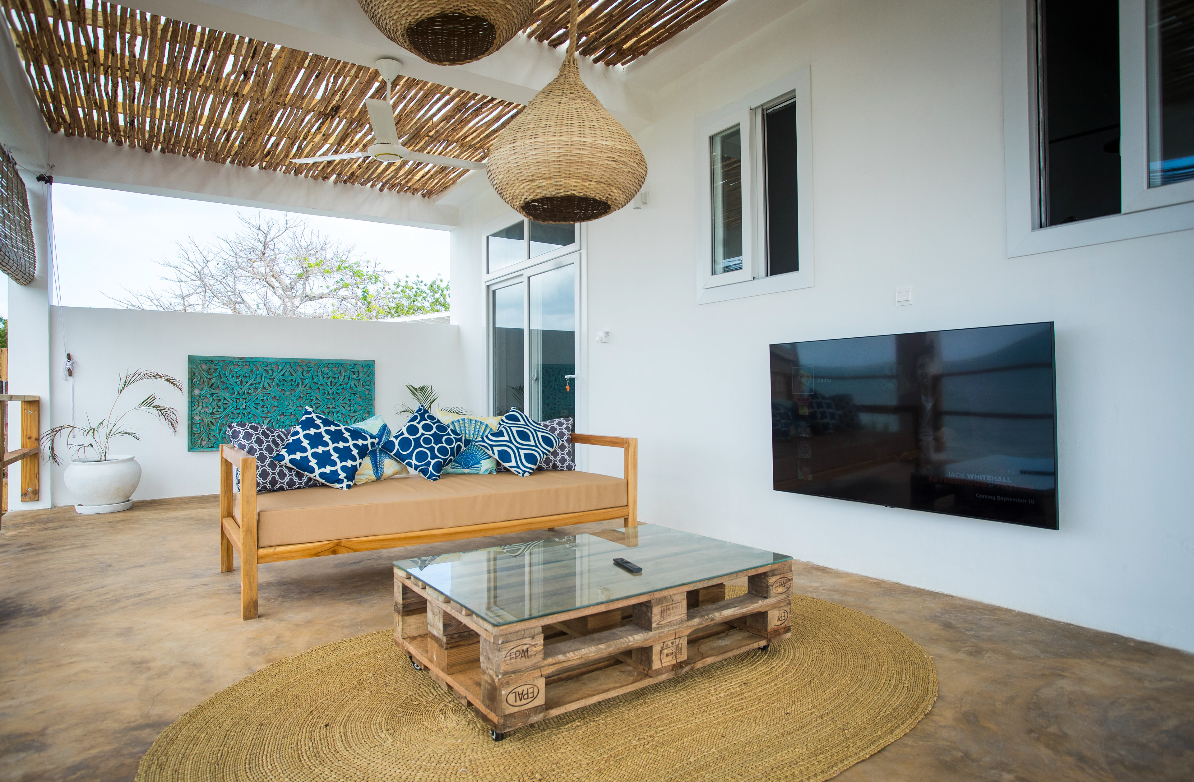 The upstairs terrace has a TV area with plenty of seating and beautiful views over the pool and out to the ocean