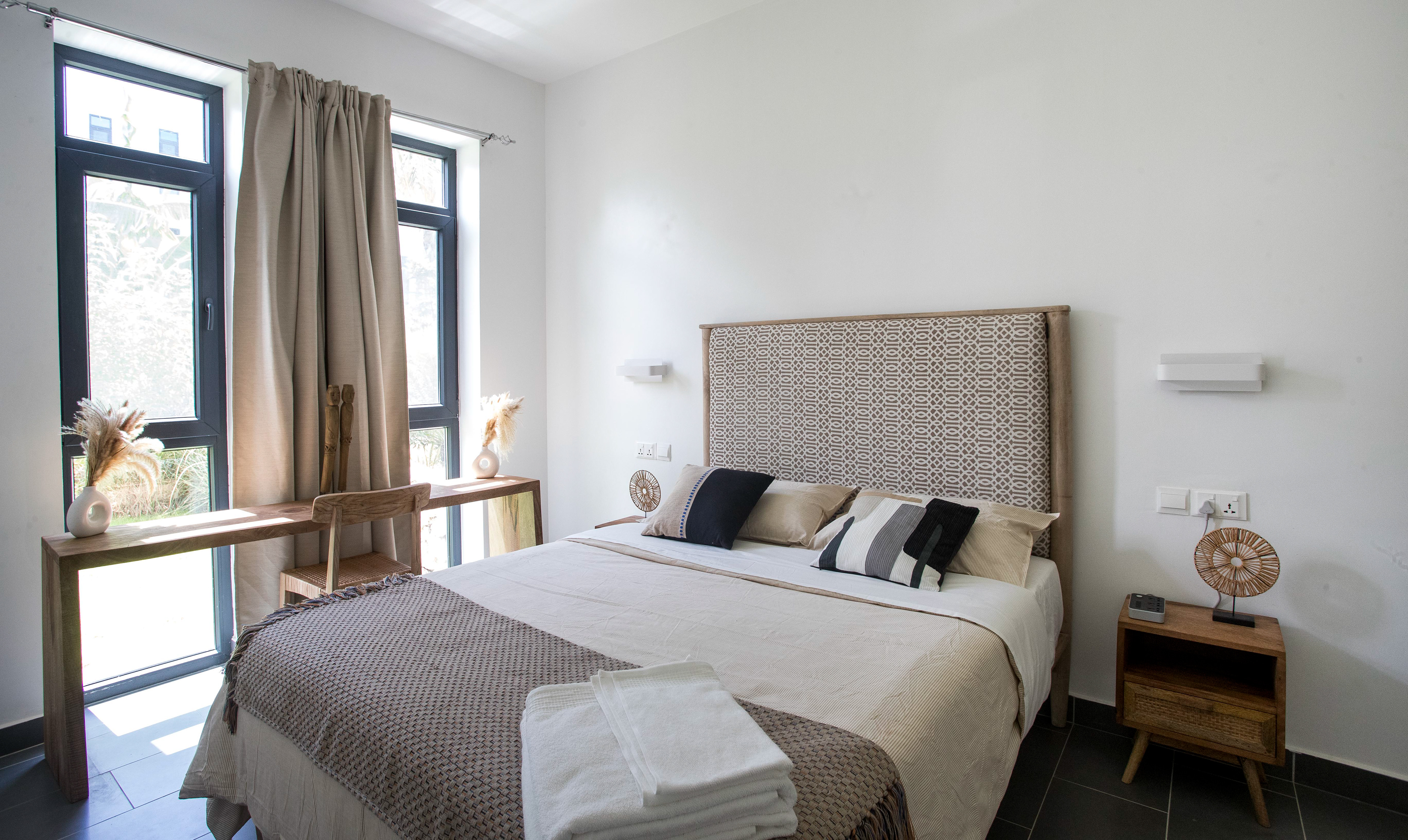 The main bedroom has a queen-size bed, quality linen and towels, and a hotel safe