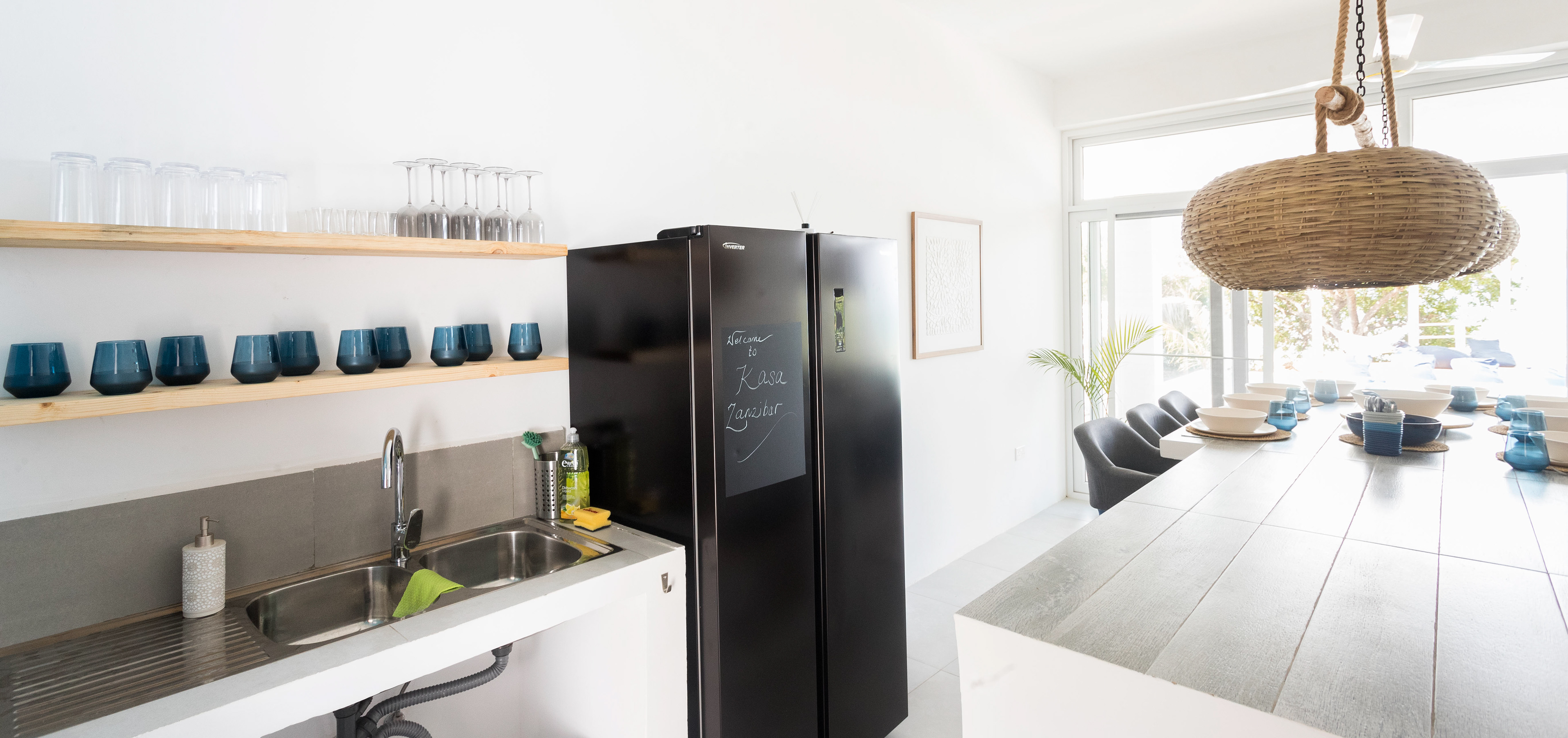 The kitchen is fully equipped for cooking and relaxing with a bar height table seating 8