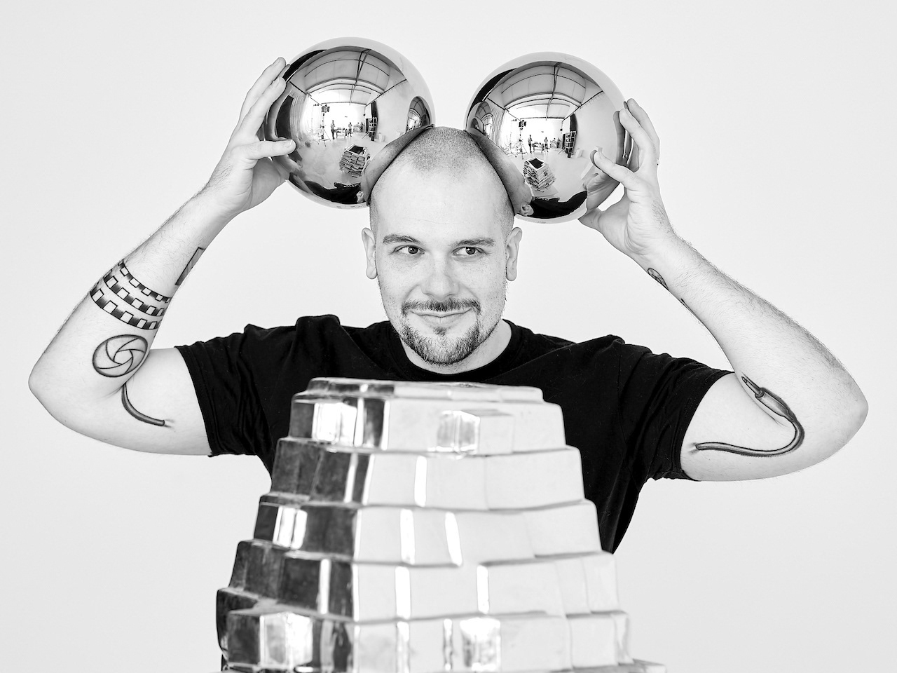Konstantin Odin having fun in the photo studio. He is holding two highly reflecting vases against his head.