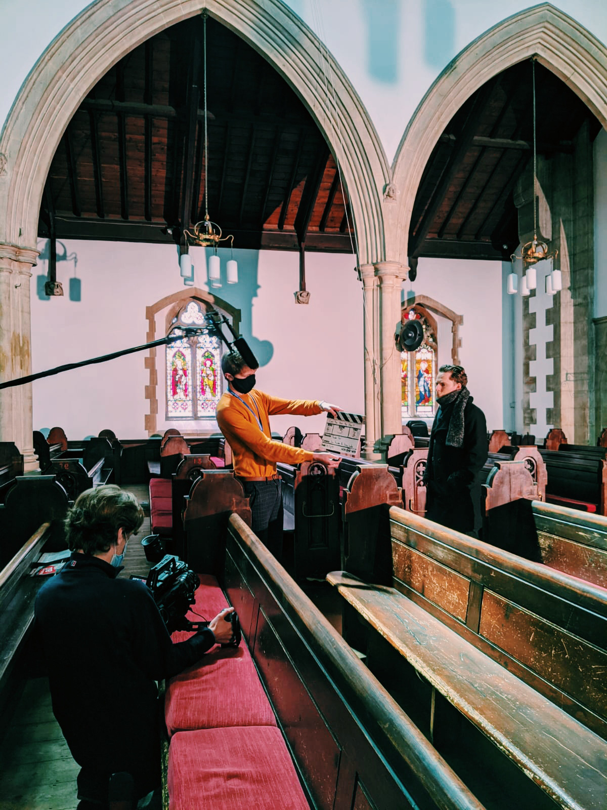 Sam Xander films and Jacob Saul uses a clapperboard.