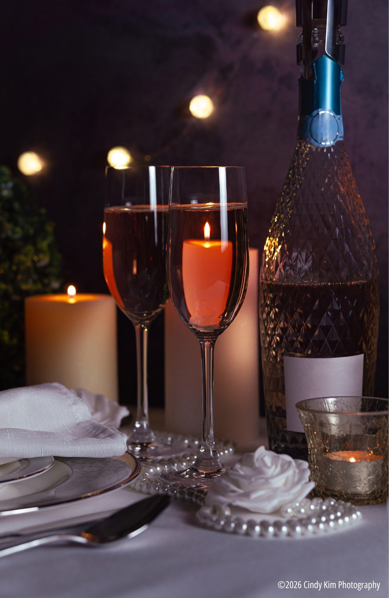 Romantic Sparkling Rosé Wine Toast with Candlelight Reflection