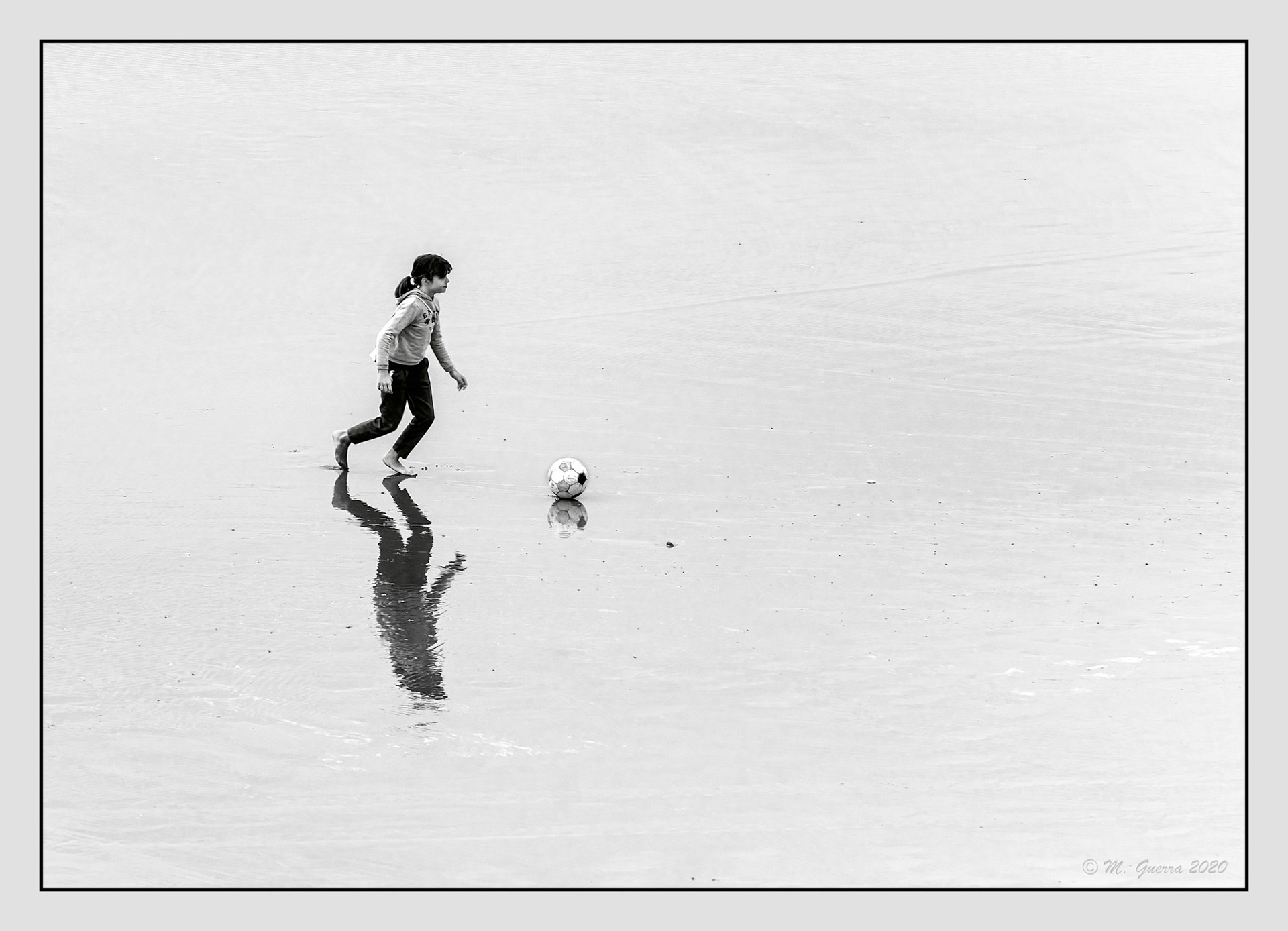 Niña jugando al balón en la playa de Ribadesella. Ampliar. 100ASA