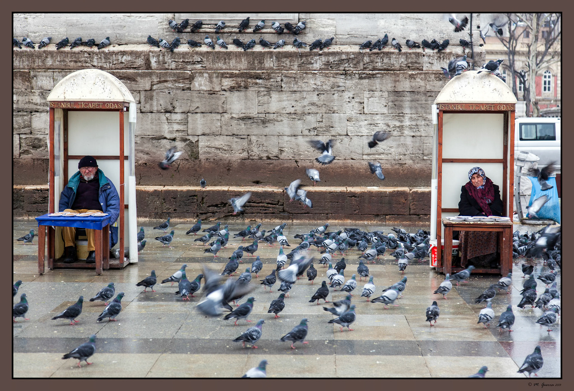 Banda de palomas al lado de lo que parece unos puestos de pobres vendiendo alpiste para las palomas a la entrada del Mercado de las Especias en Estambul. Ampliar. 100ASA