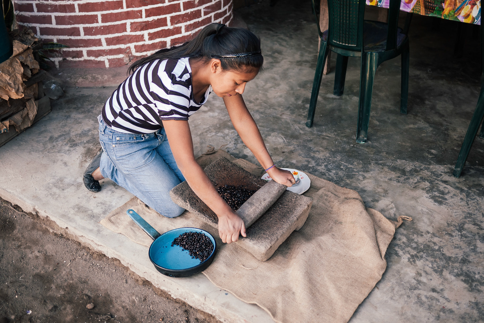 Don Filiberto's daughter showed us the way to grind beans by hand.