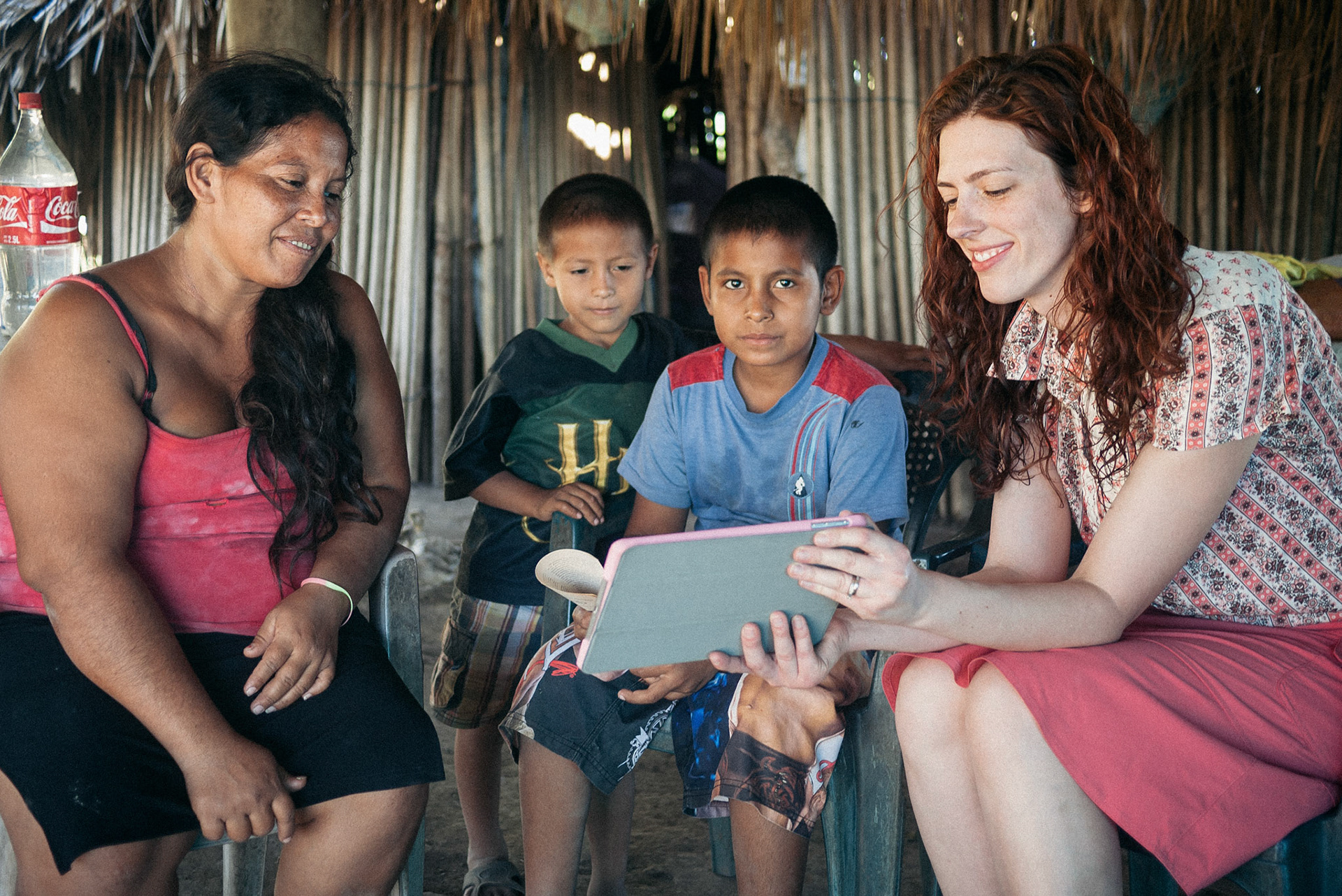 Jess showing a Caleb & Sophia video to two young boys.