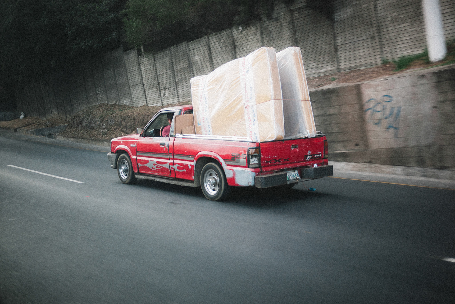 A typical example of a truck on Guatemalan roadways. Many small pickups were far more overloaded, or even invisible under their towering cargo, leading to Nathan's invention of the "There's a Truck in There Somewhere" driving game.