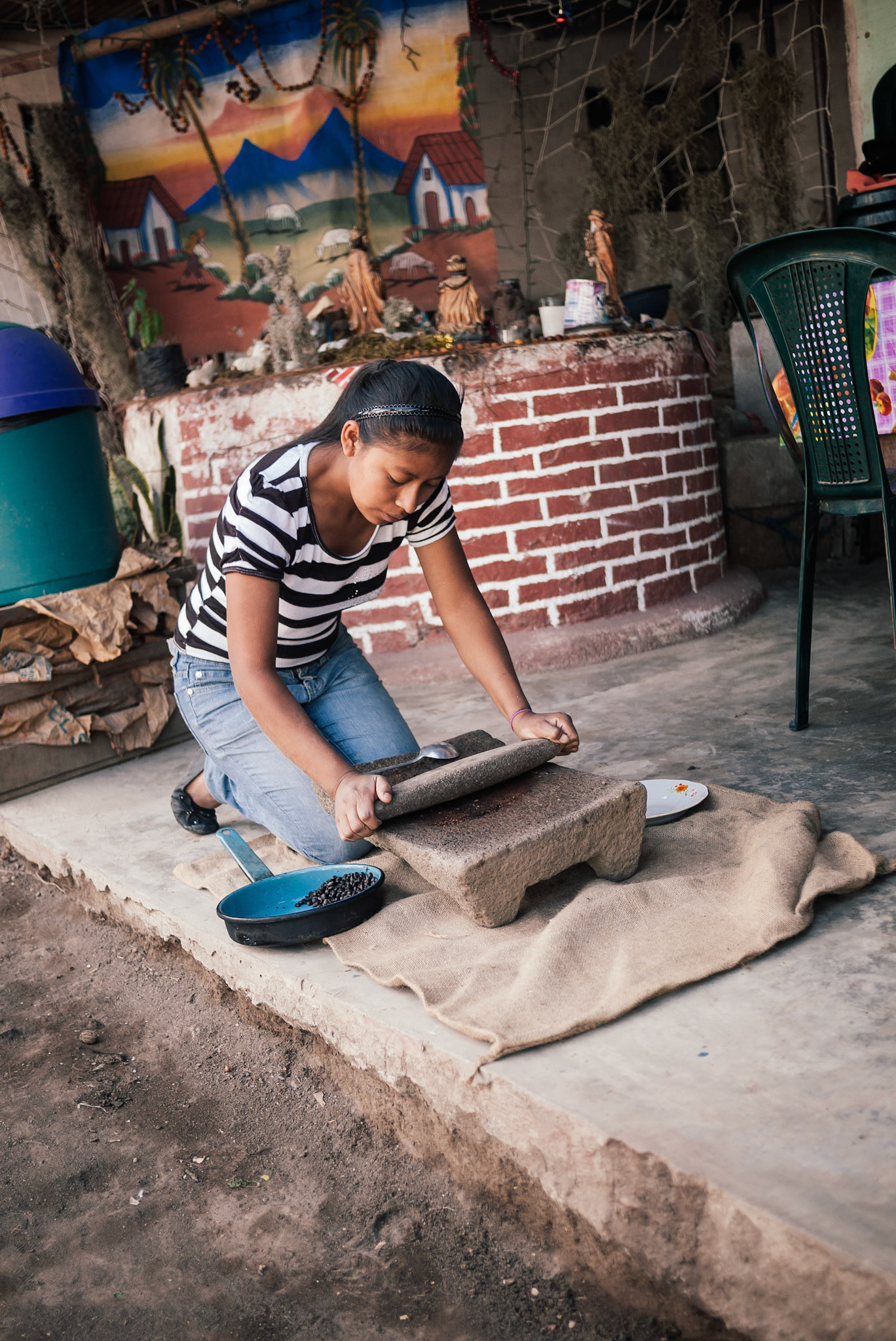 Don Filiberto's daughter showed us the way to grind beans by hand.