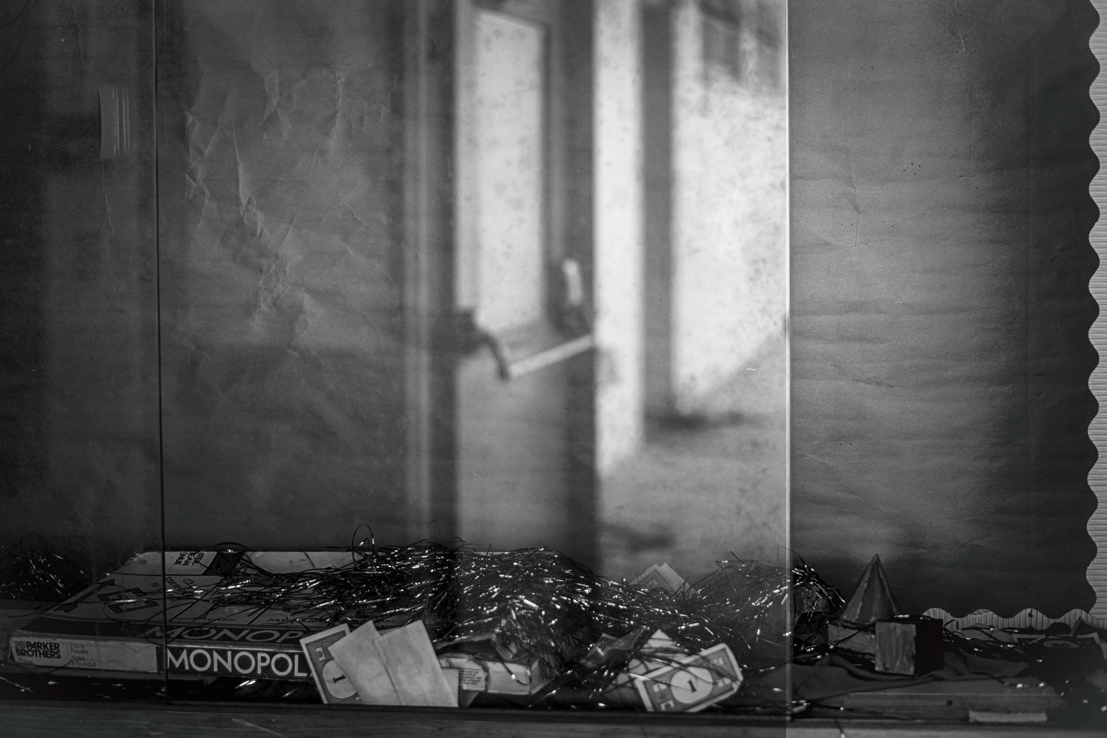 Glass of trophy case reflect image of open door