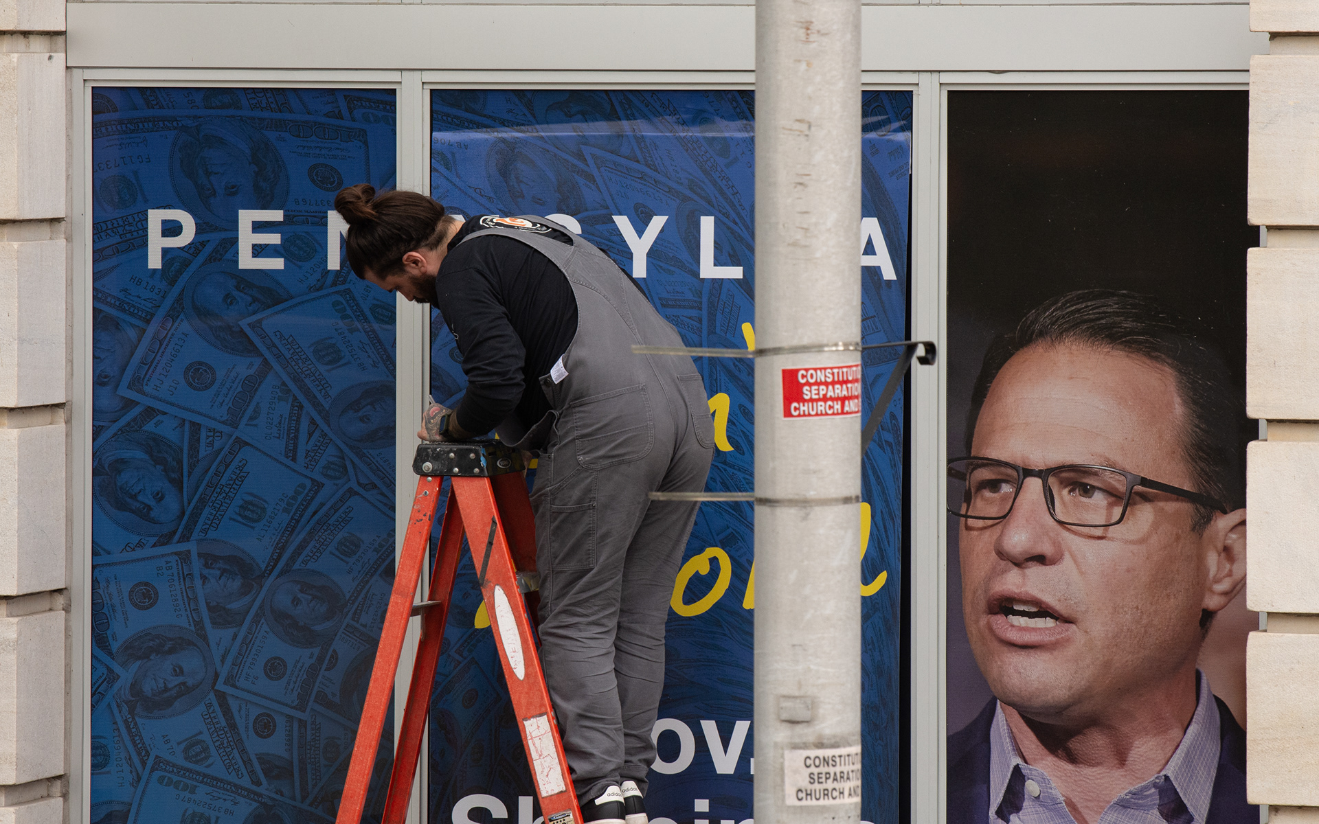 Harrisburg, PA, April 13, 2026 - A new marketing panel for Pennsylvania Gov. Josh Shapiro is posted on the window of a building across from the Capitol today. 