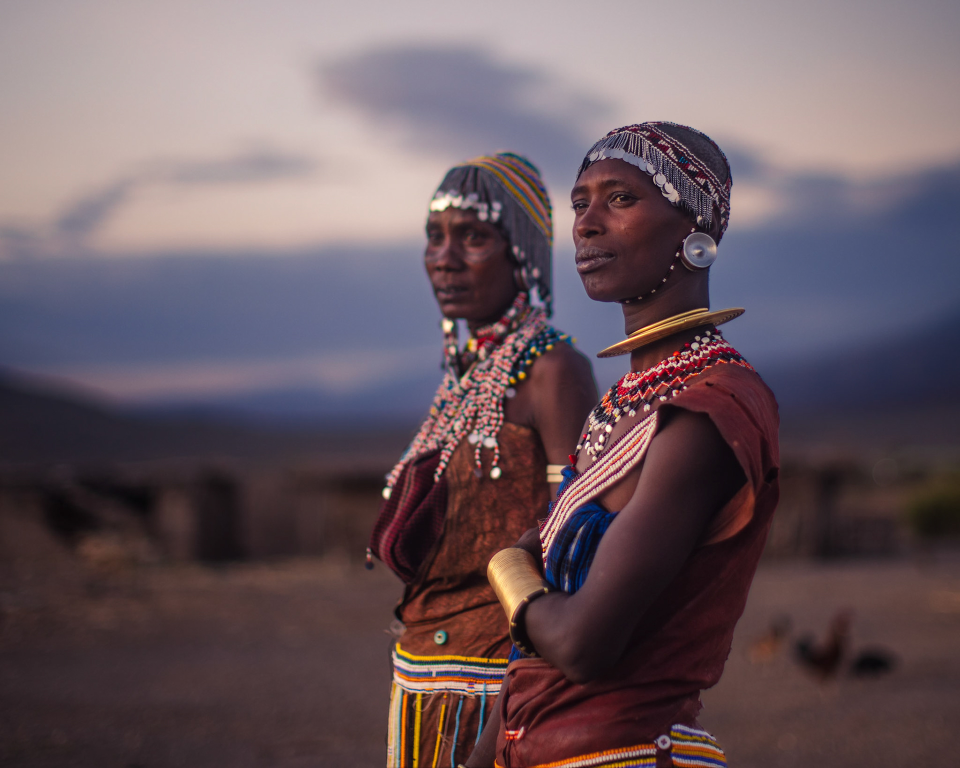 Sisters of the Savannah — Standing against the vast horizon of the Lake Eyasi region, these women represent the strength of the Datoga people. Their traditional attire contrasts beautifully with the open landscape, showcasing their adaptation to life in this rugged, beautiful terrain.