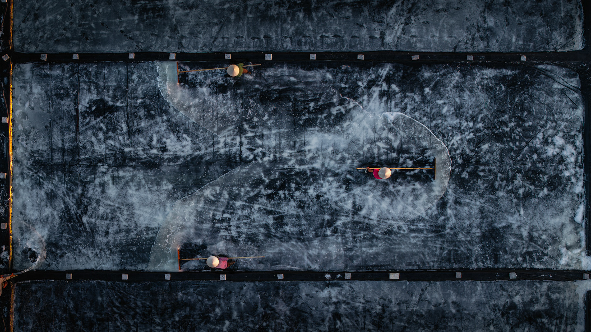 Scale and isolation within the grand, abstract geometry of the Vietnamese salt harvest.